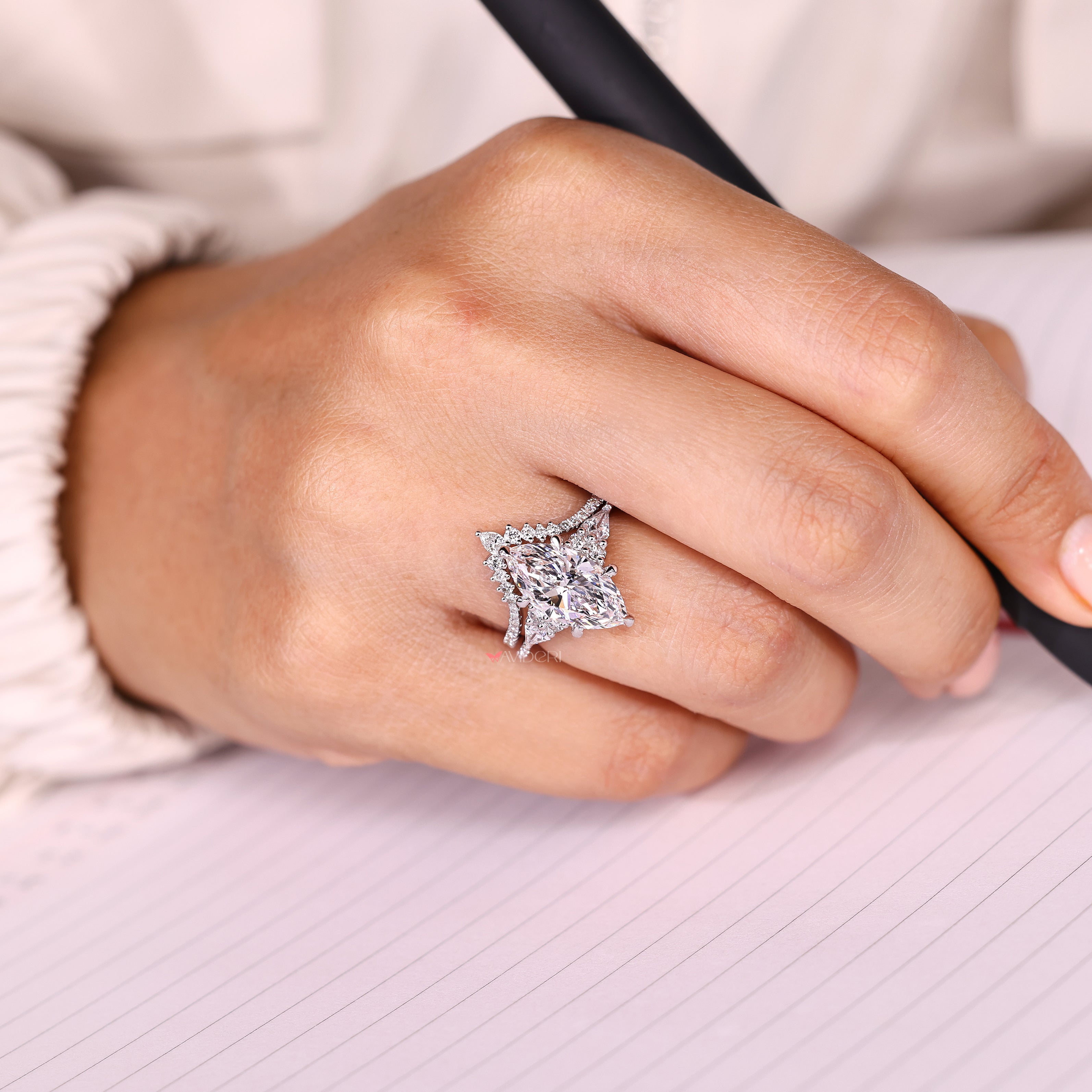 Engagement ring with kite side stones and pave.
