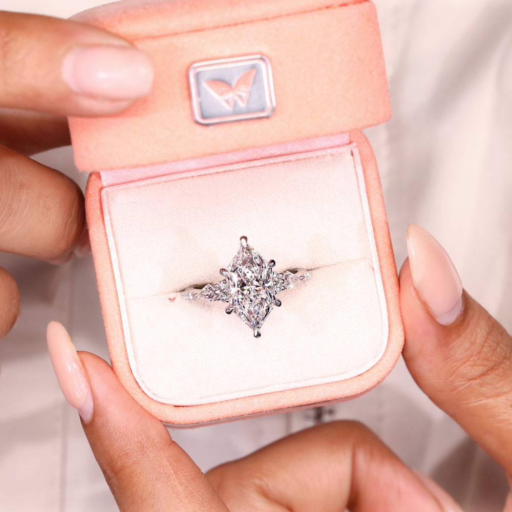 Lab grown Dutch marquise ring with round accent stones

