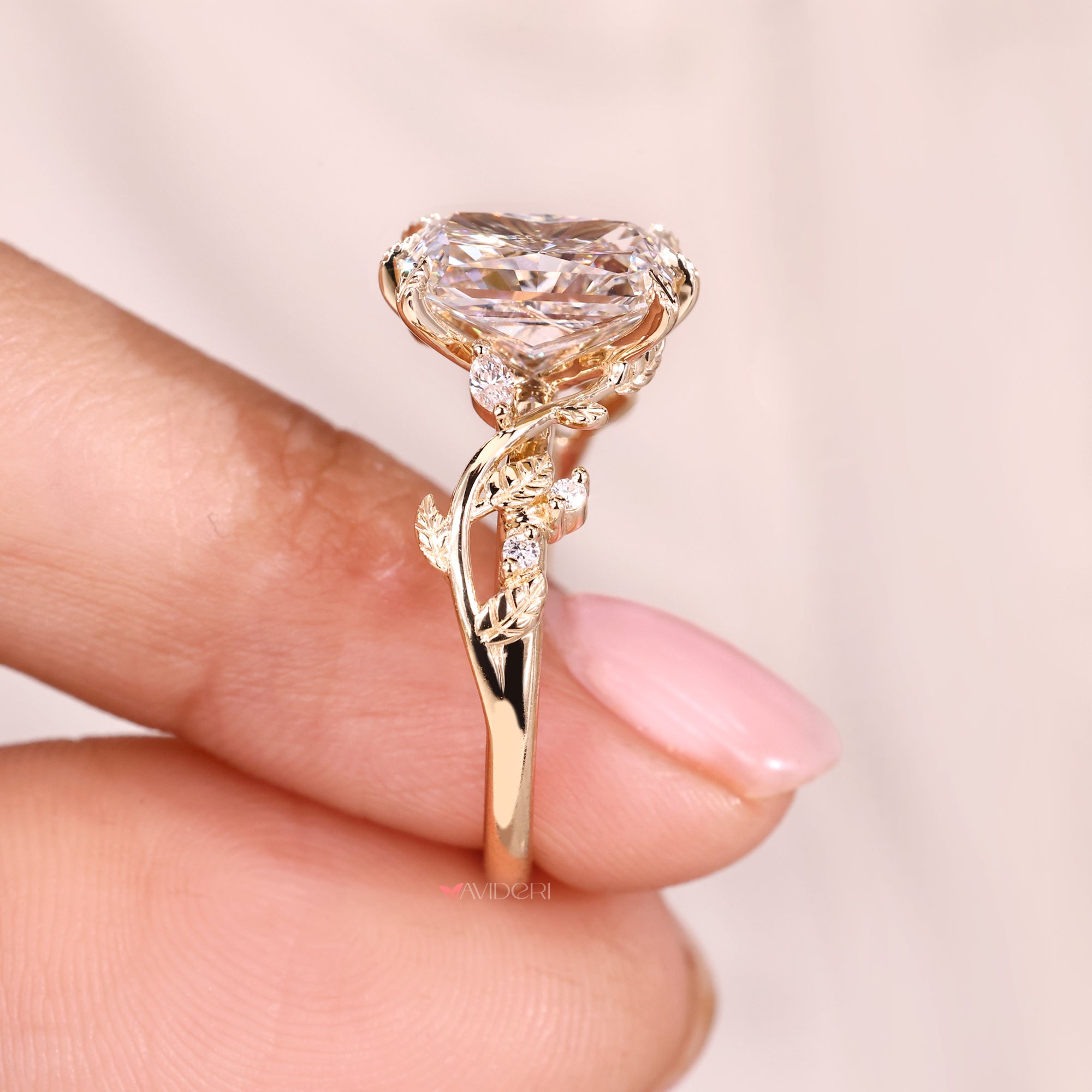 Marquise and round side stone in leaf style prong.
