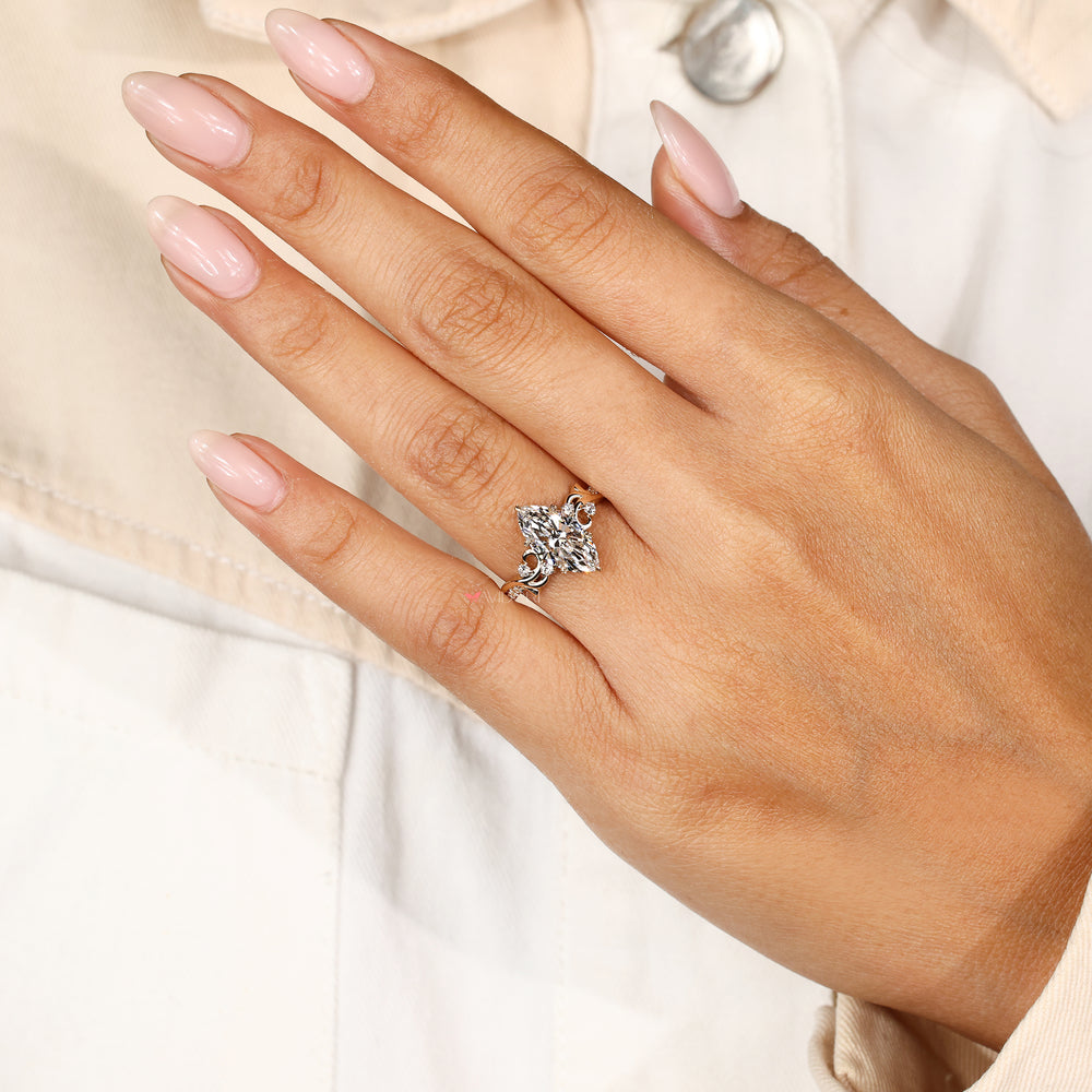 Nature inspired engagement ring with marquise diamond centerpiece design
