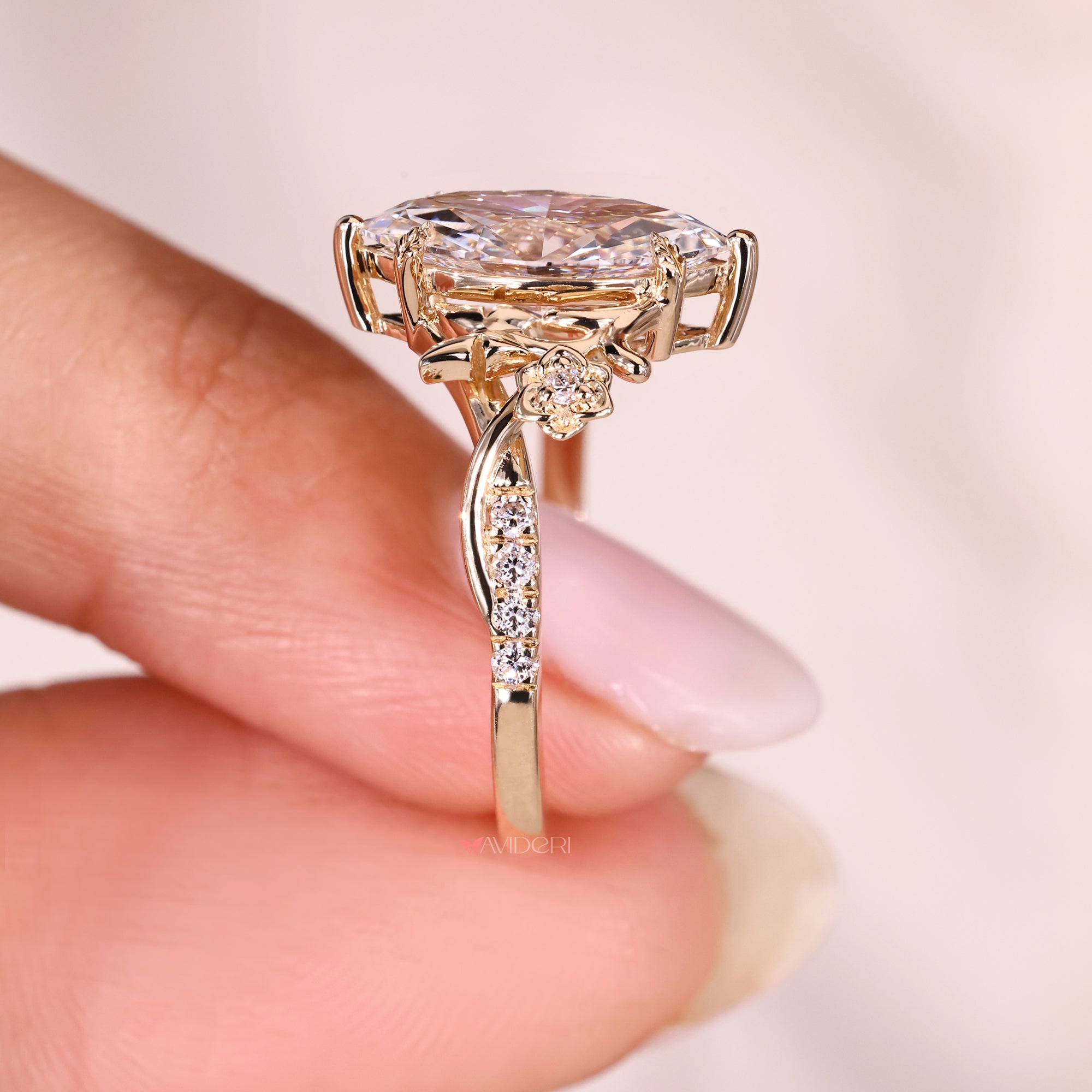 Marquise diamond ring with cathedral setting design.
