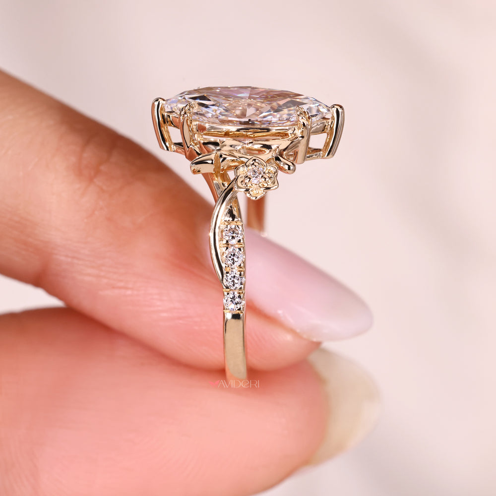 Marquise diamond ring with cathedral setting design.
