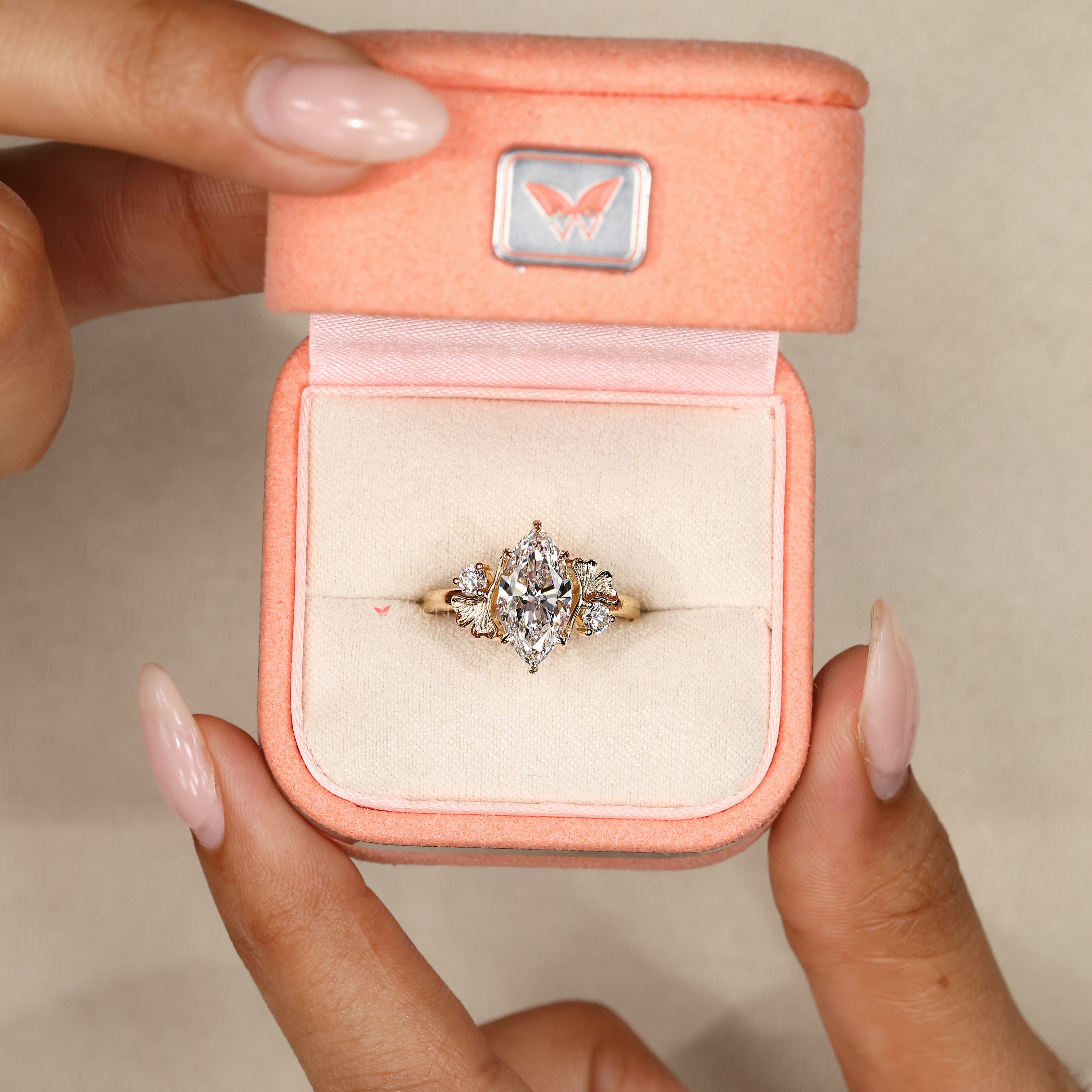 Marquise ring with round cut side stone accents.
