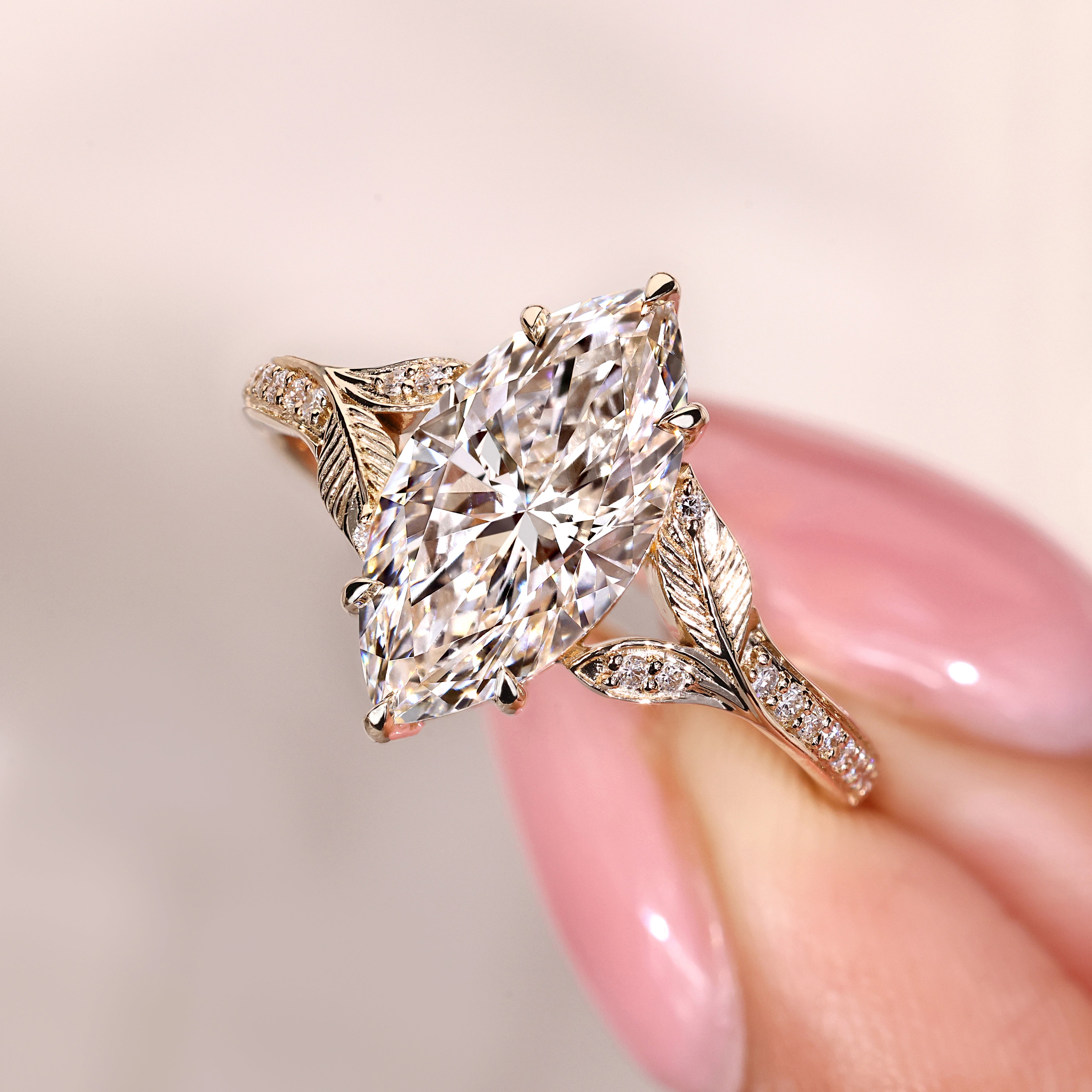 Marquise diamond ring with split leaf shank and side stones
