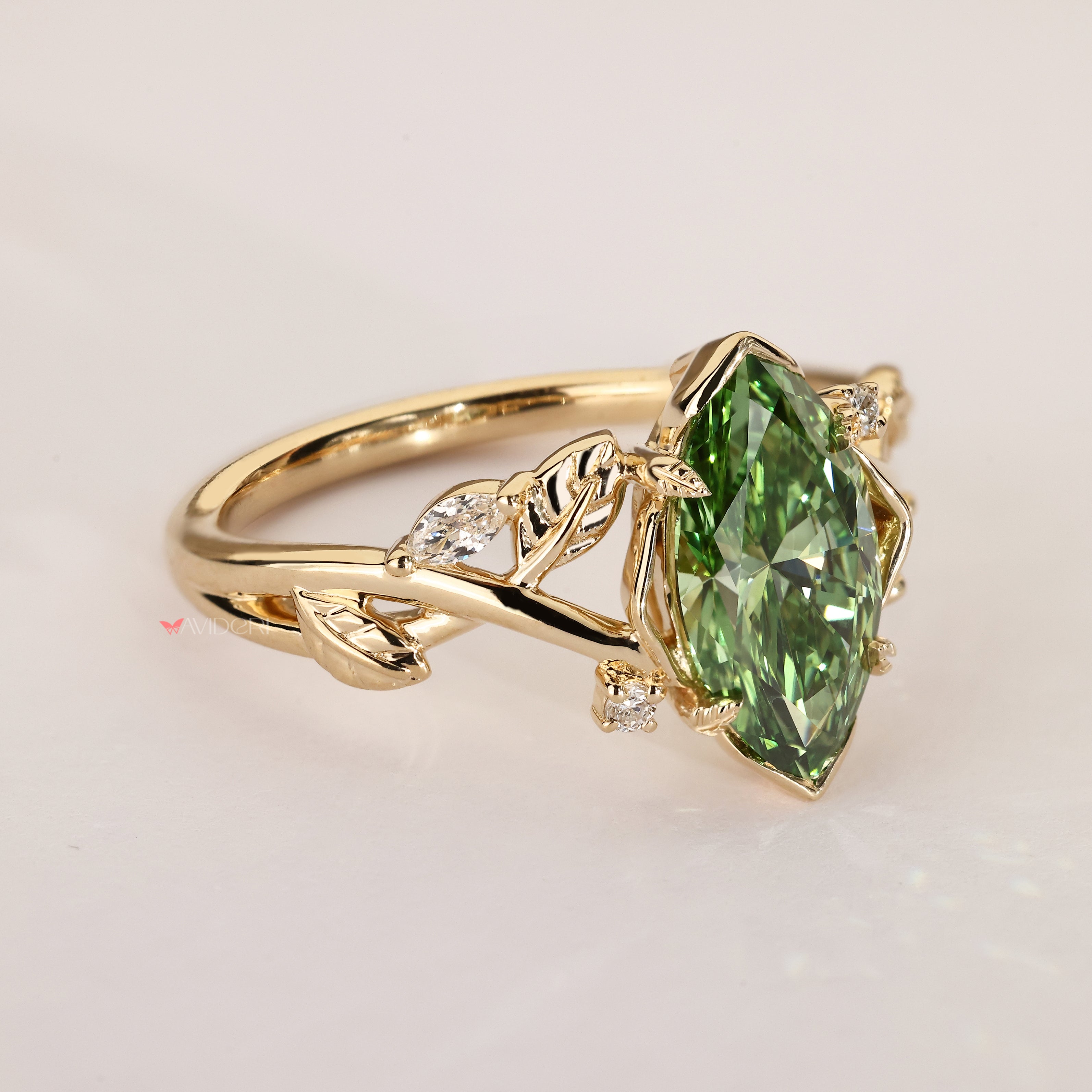 Marquise green diGreen marquise ring with nature inspired design.
amond ring with vine detailing.
