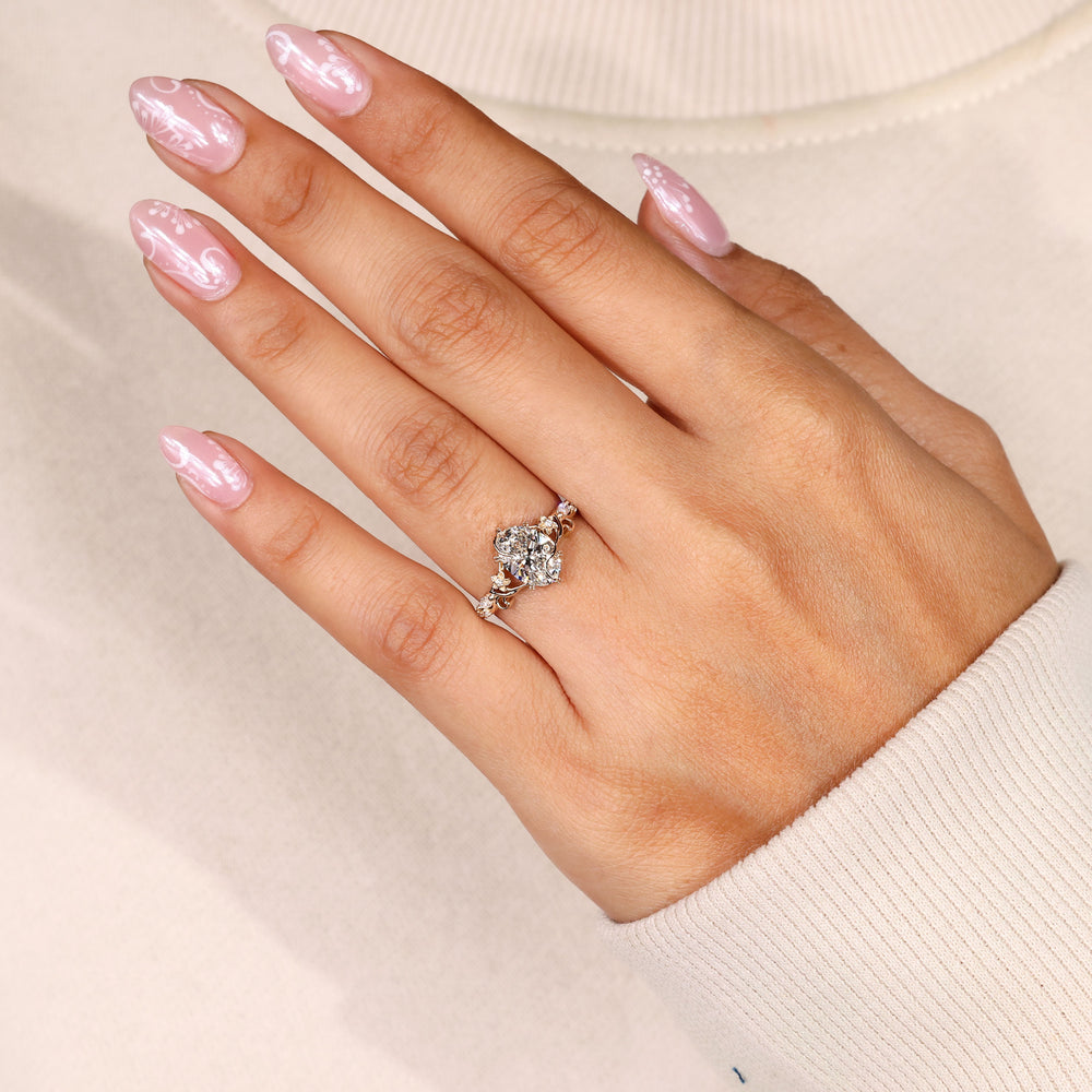 Oval engagement ring with twisted floral vine design.
