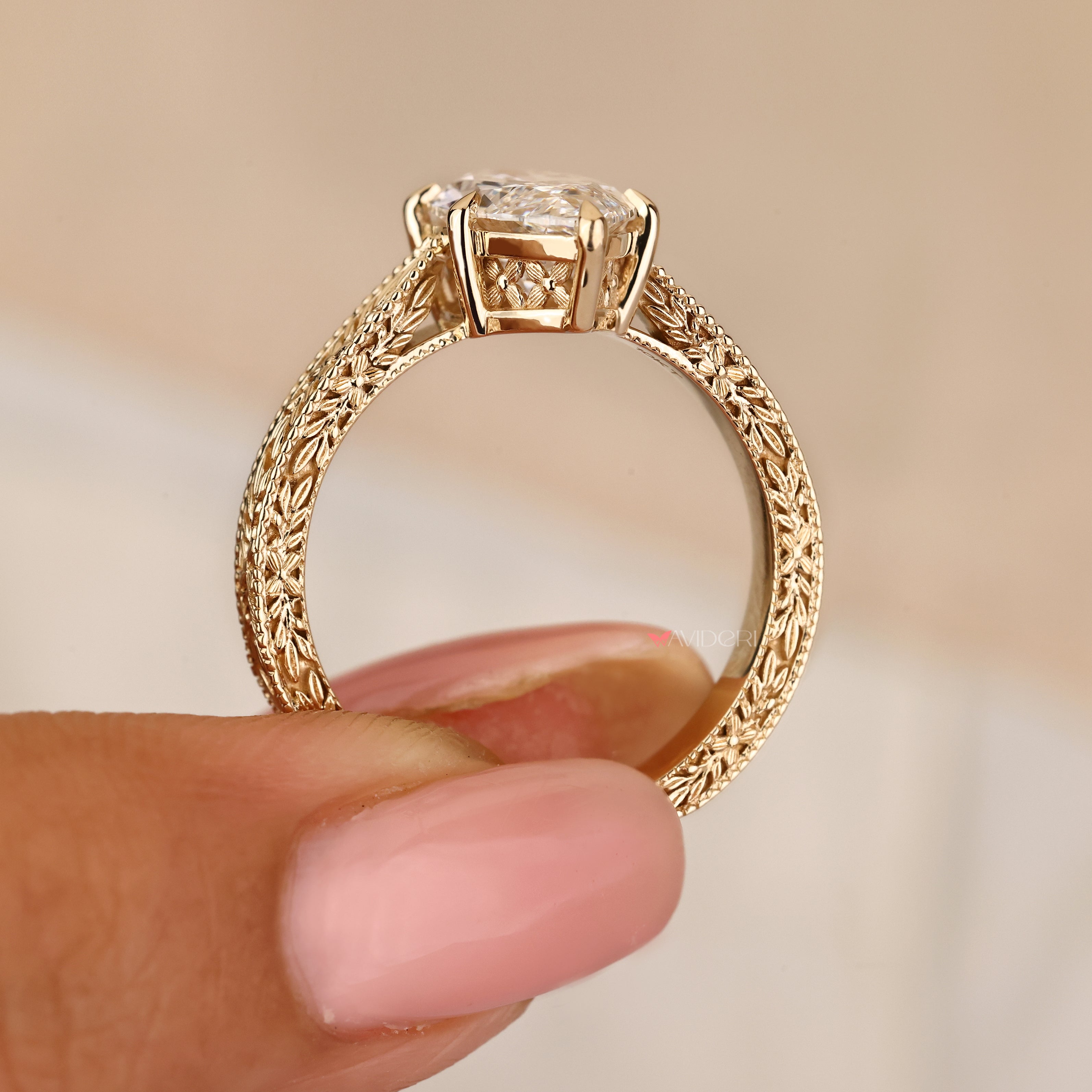 Marquise diamond ring with engraved band and claw setting
