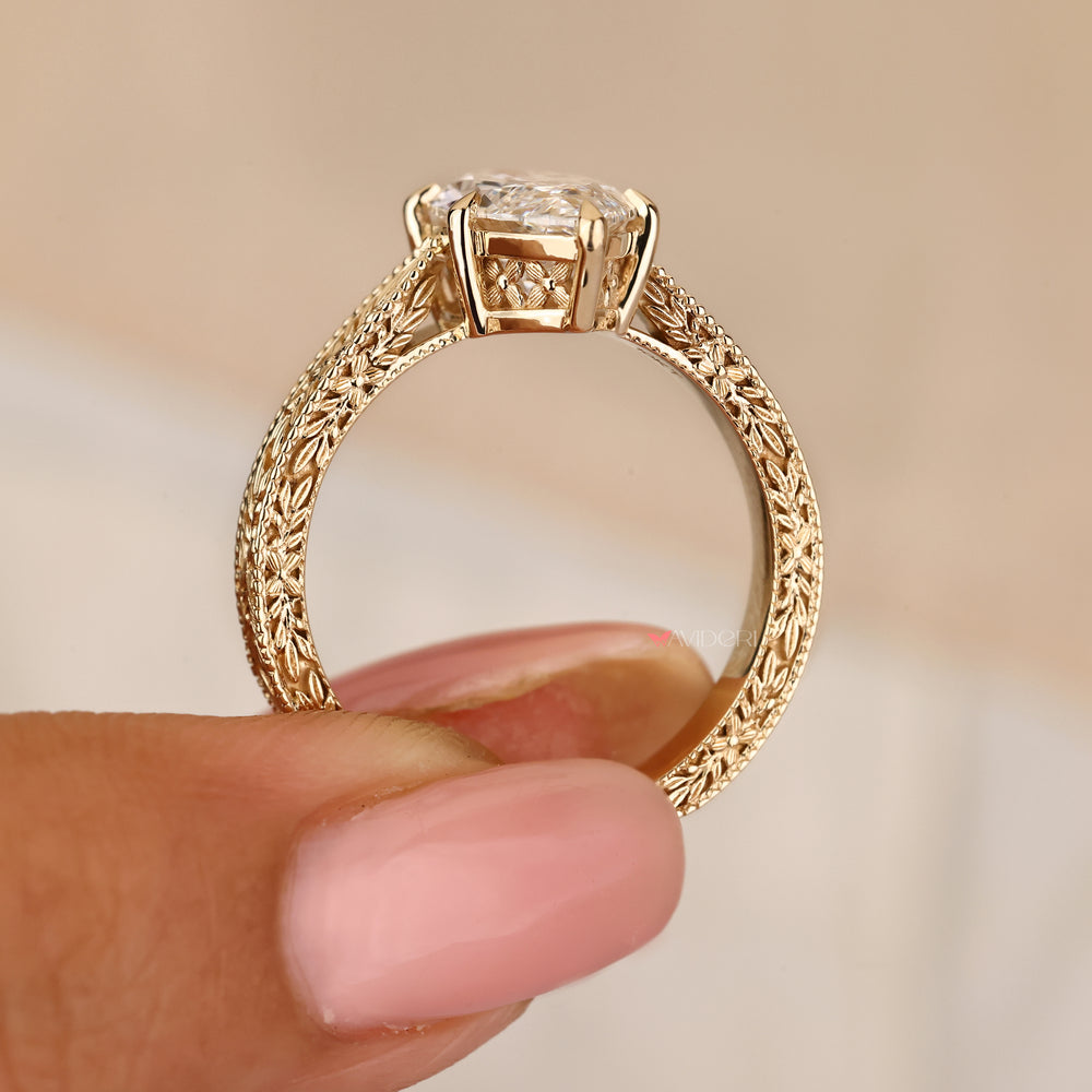 Marquise diamond ring with engraved band and claw setting
