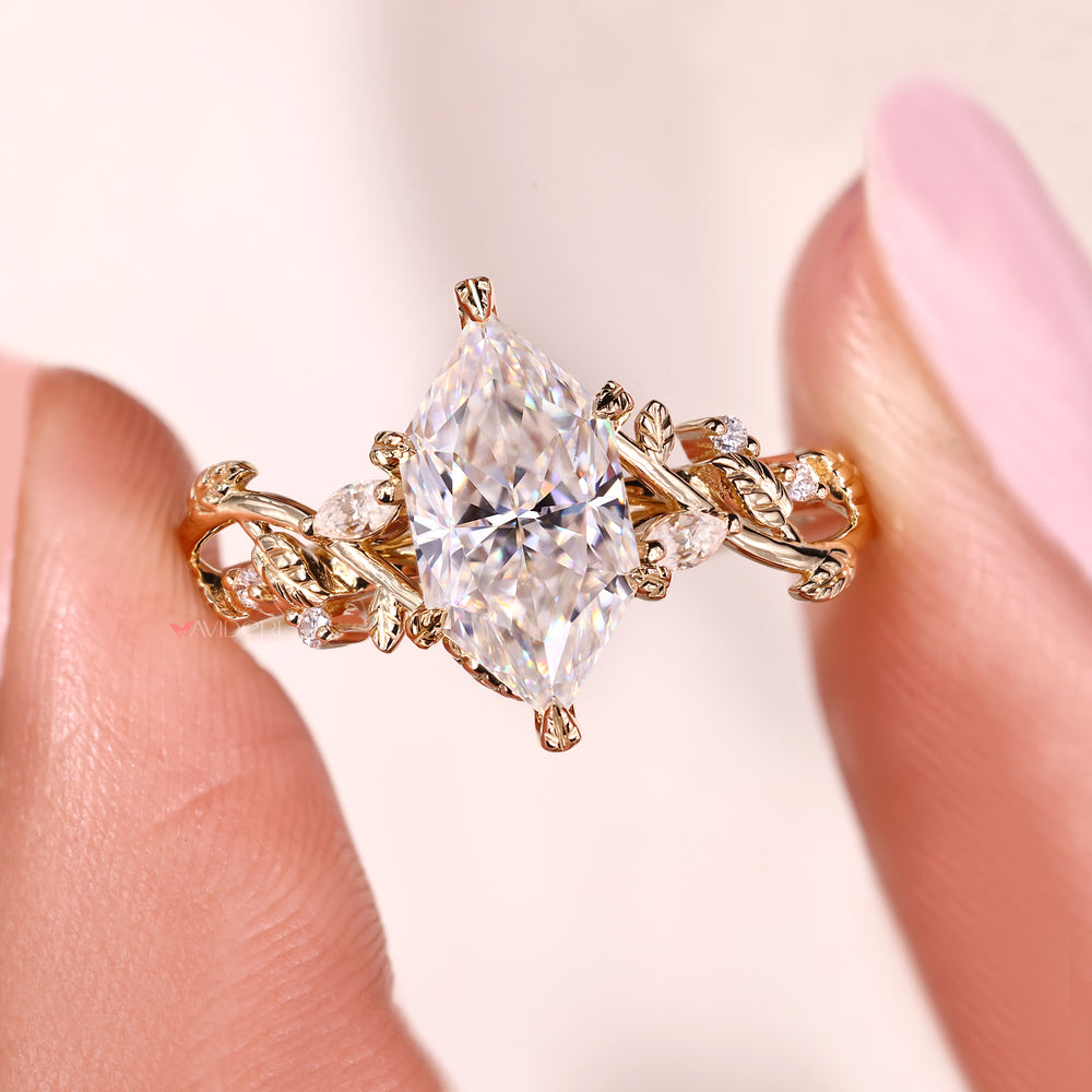 Moissanite engagement ring with leaf style prongs.