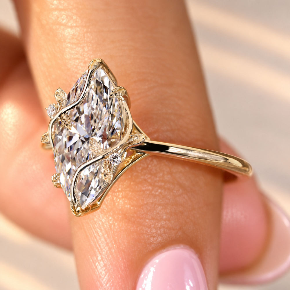 Handmade marquise ring with round diamond side stones.
