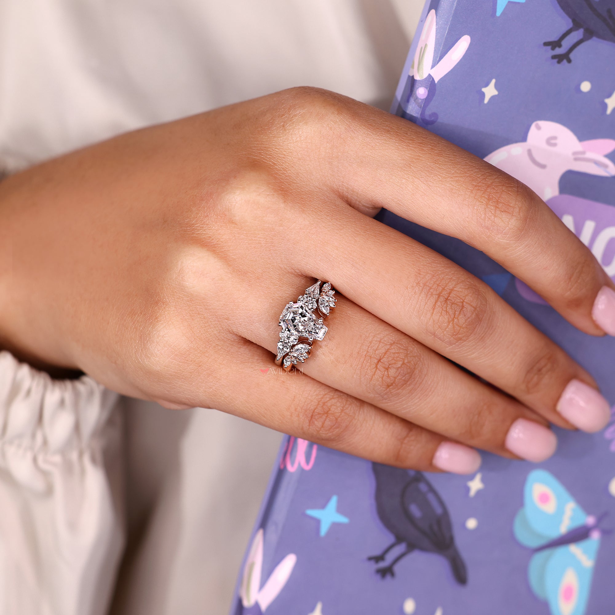 Coffin cut engagement ring with kite cut side stones.