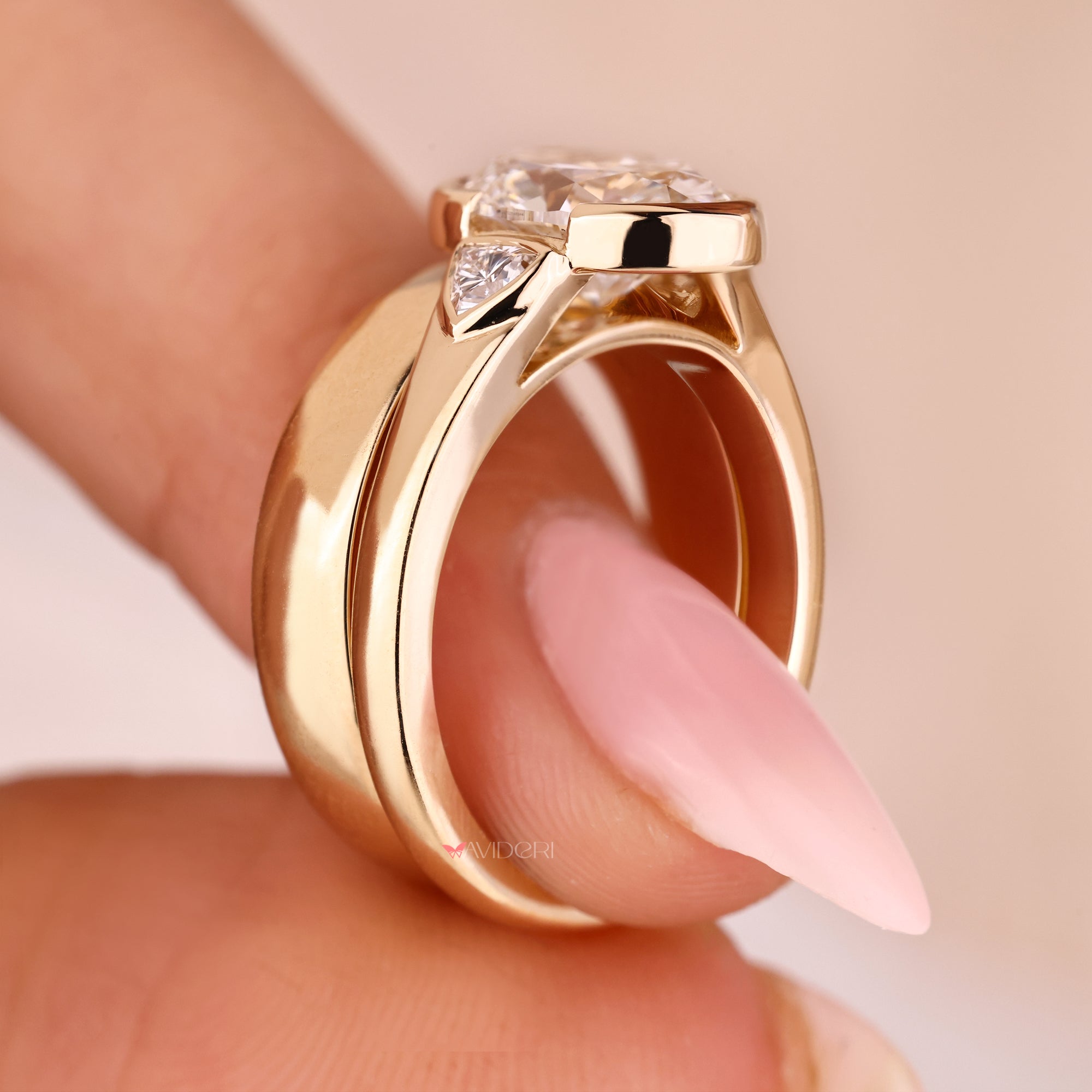 Tapered shank ring with a cathedral setting ring design.