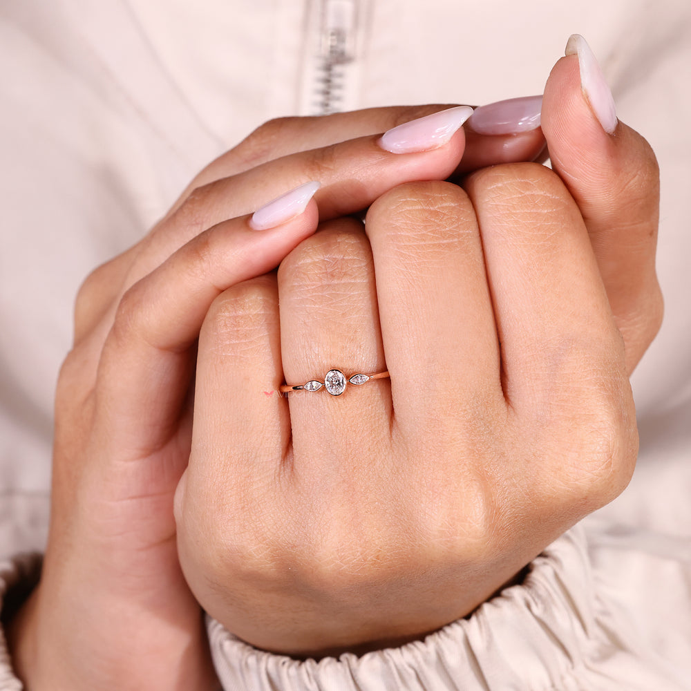 Three stone diamond ring with smooth bezel setting.
