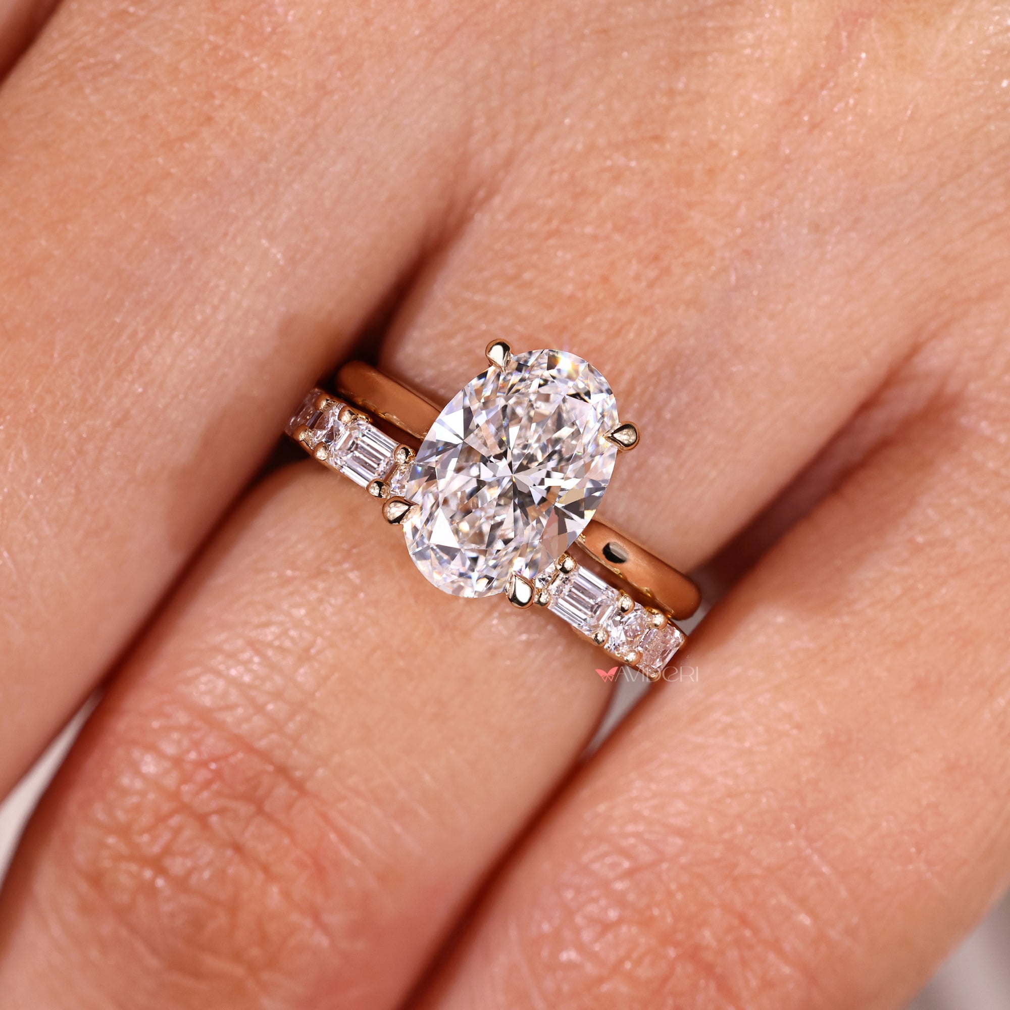 Oval diamond ring with round and emerald cut bridal set.