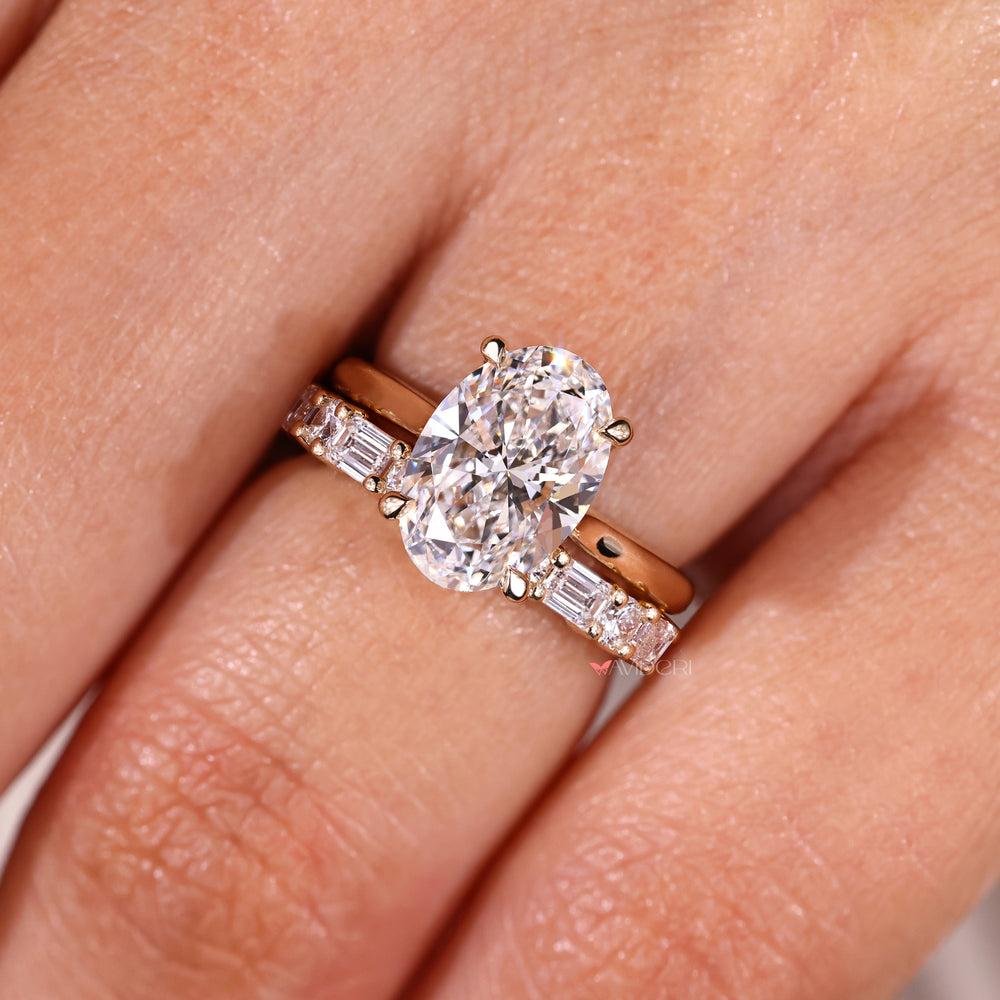 Oval diamond ring with round and emerald cut bridal set.
