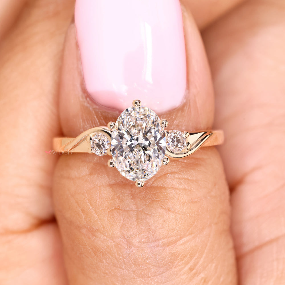 Three stone oval diamond ring with basket setting details
