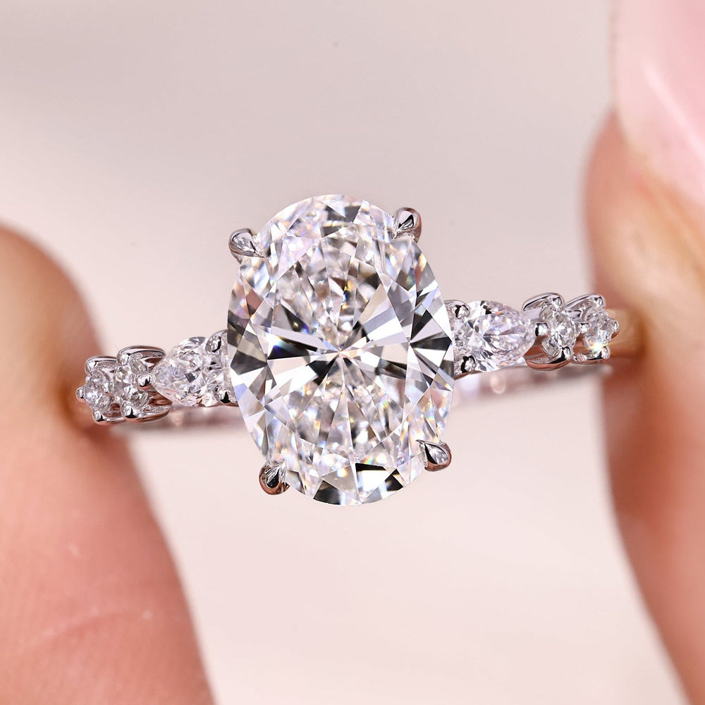 Oval Cut Diamond Ring with Pear Side Stones.