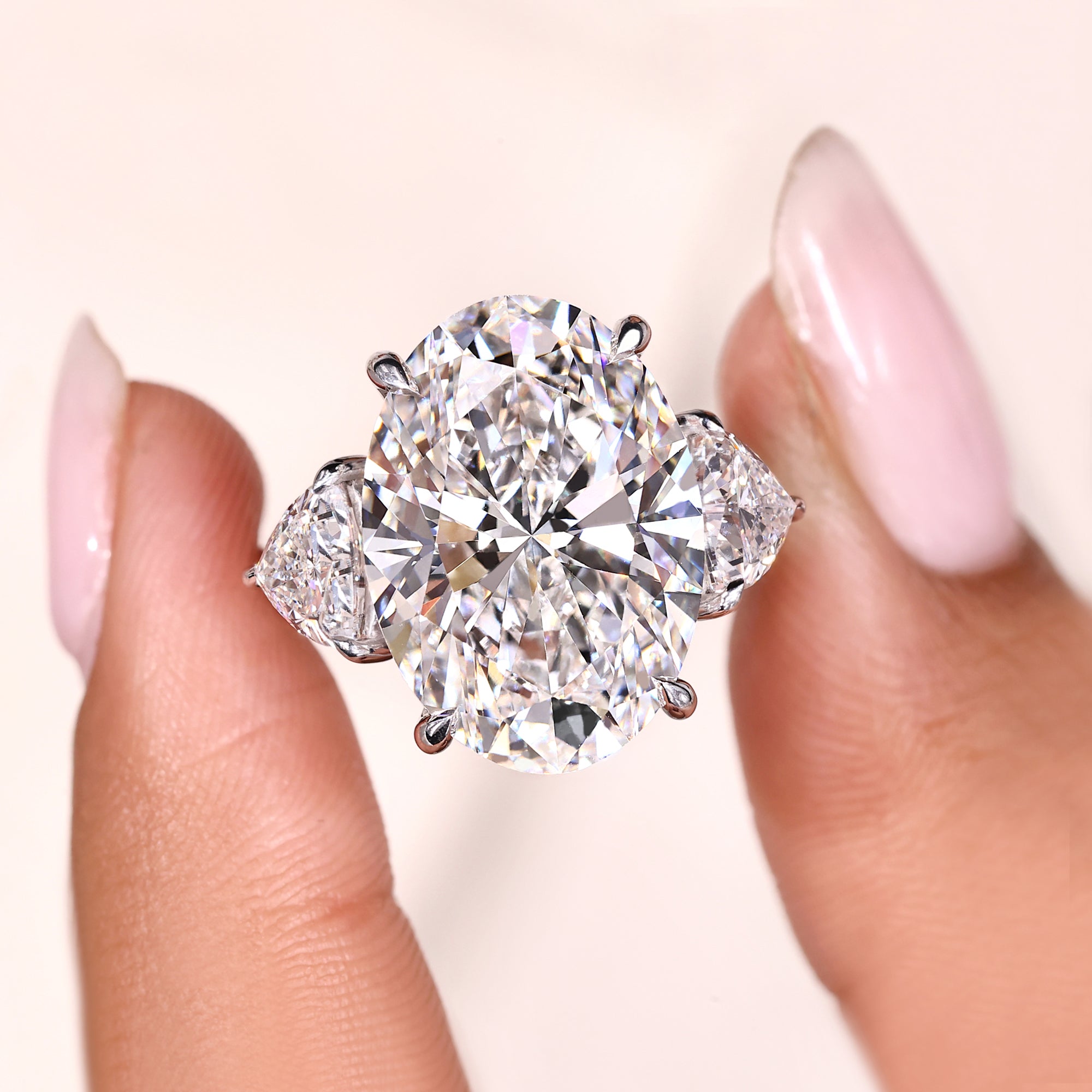 White Gold Three Stone Diamond Ring with Oval Center.