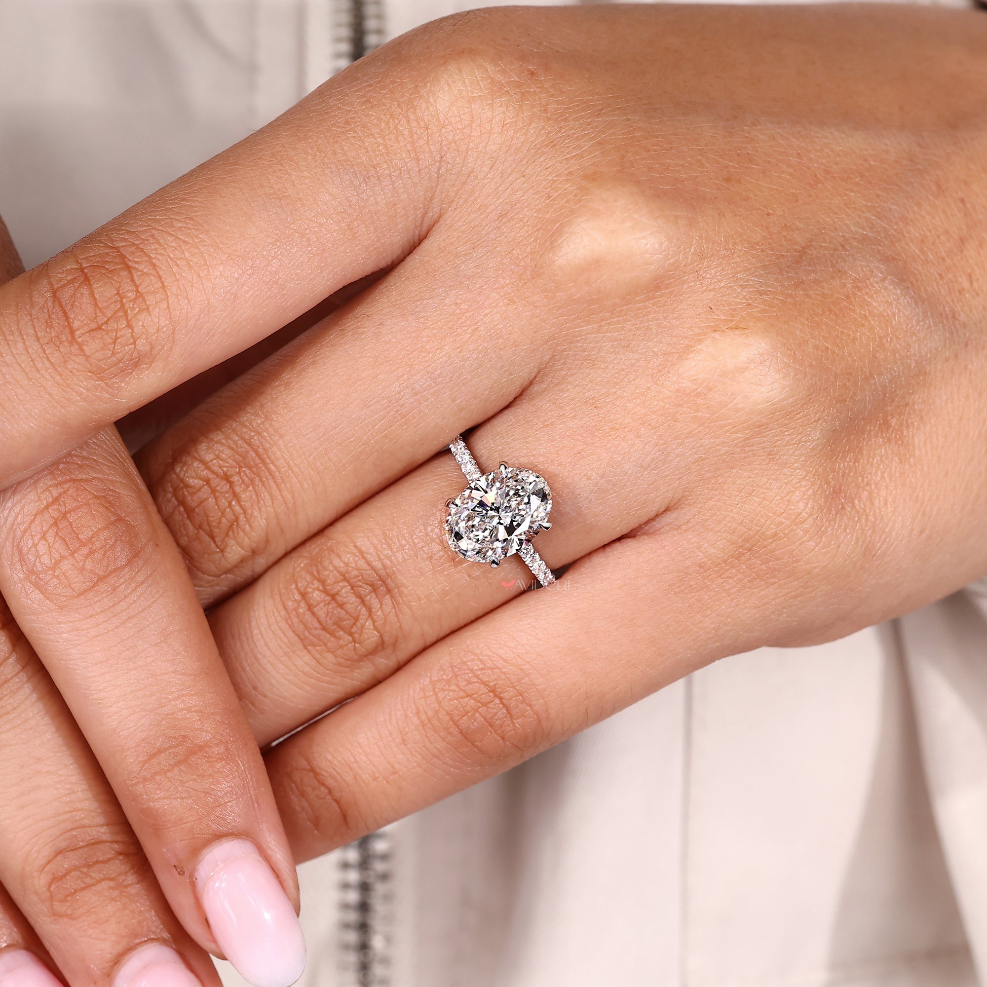 Oval lab grown diamond ring with open gallery.