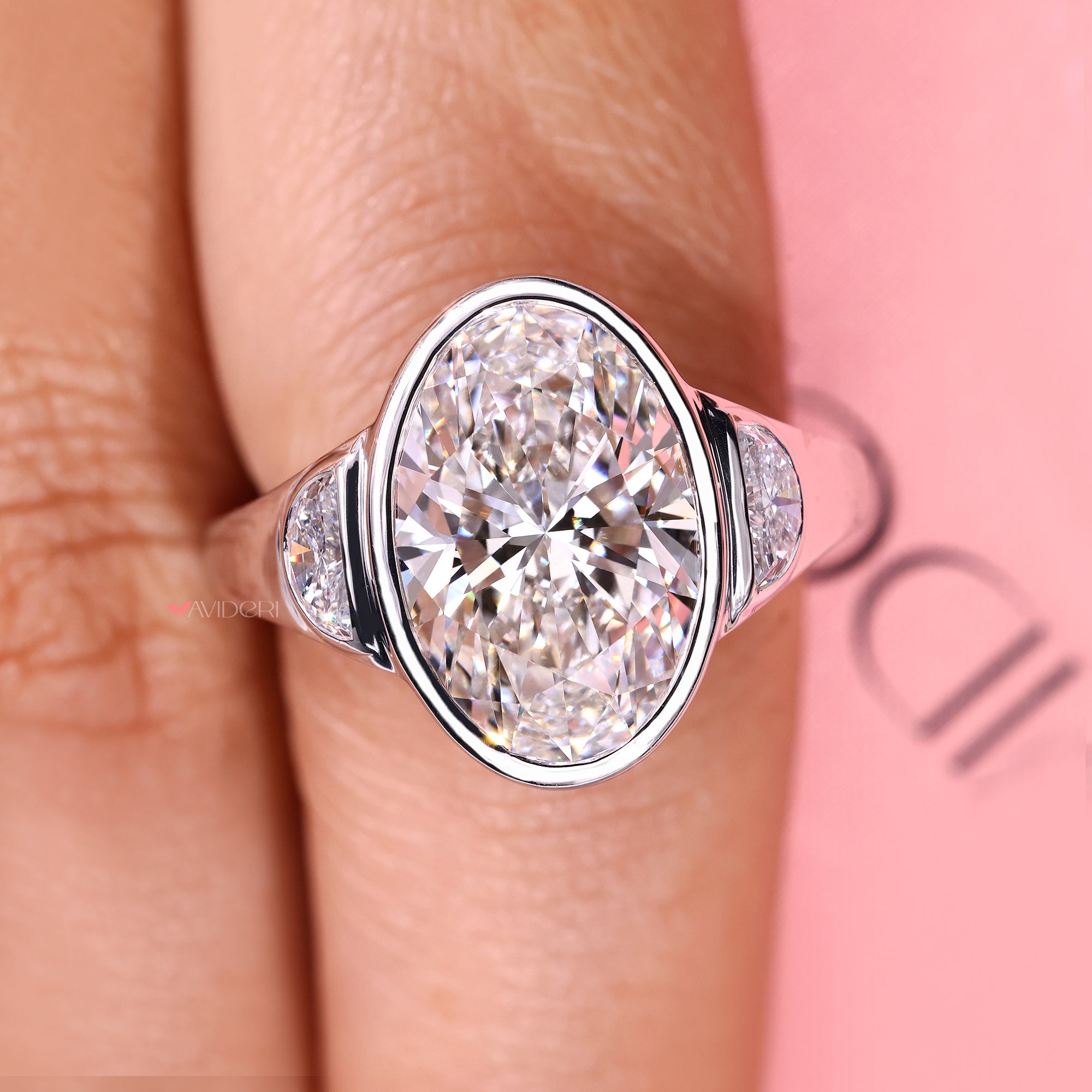 Oval cut diamond three stone ring with cathedral setting.
