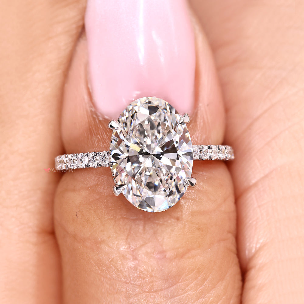 Oval diamond engagement ring with round halo details.