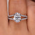 Oval cut diamond ring with hidden halo and split pave band.
