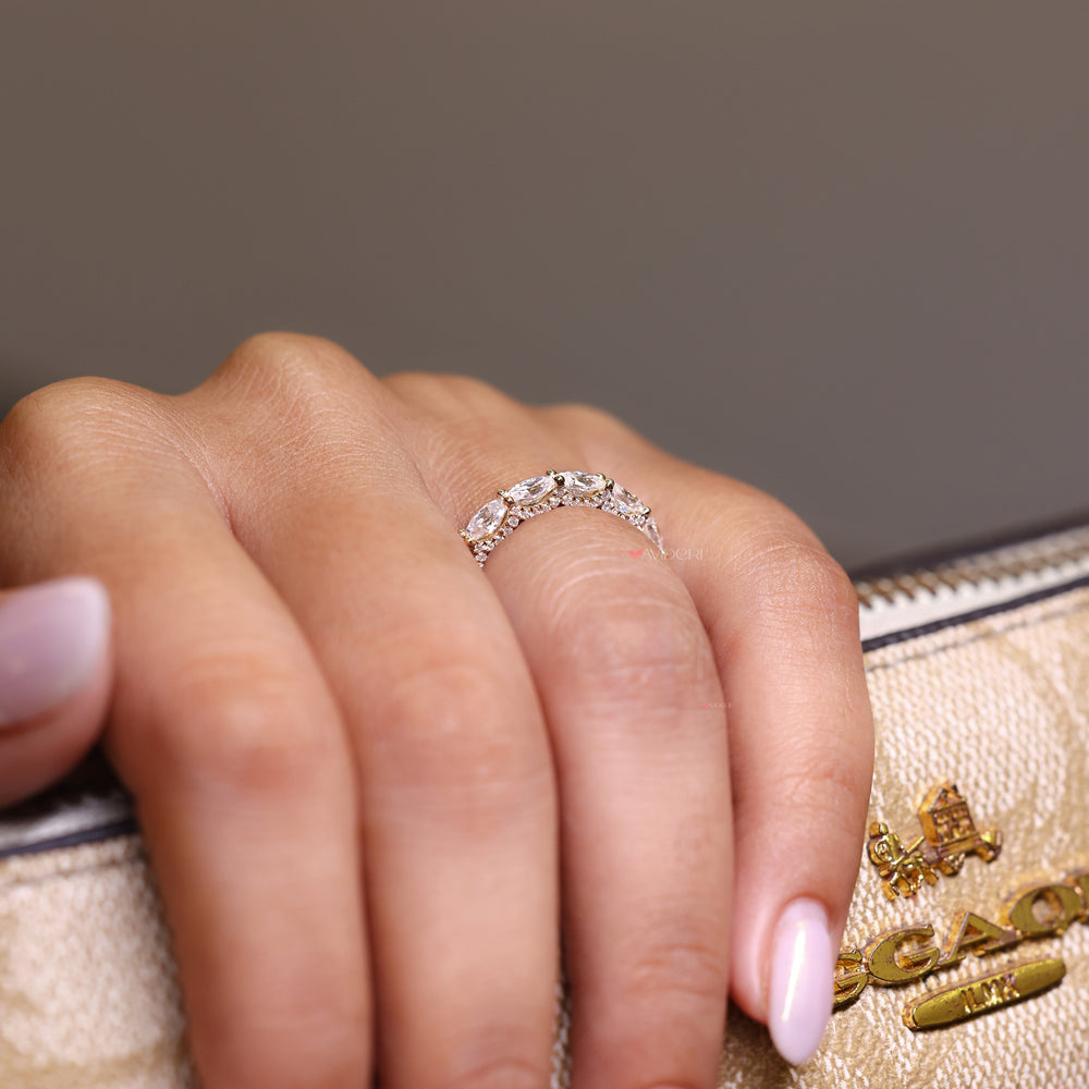 Round cut pave moissanite wedding band styled in a micro u prong setting.
