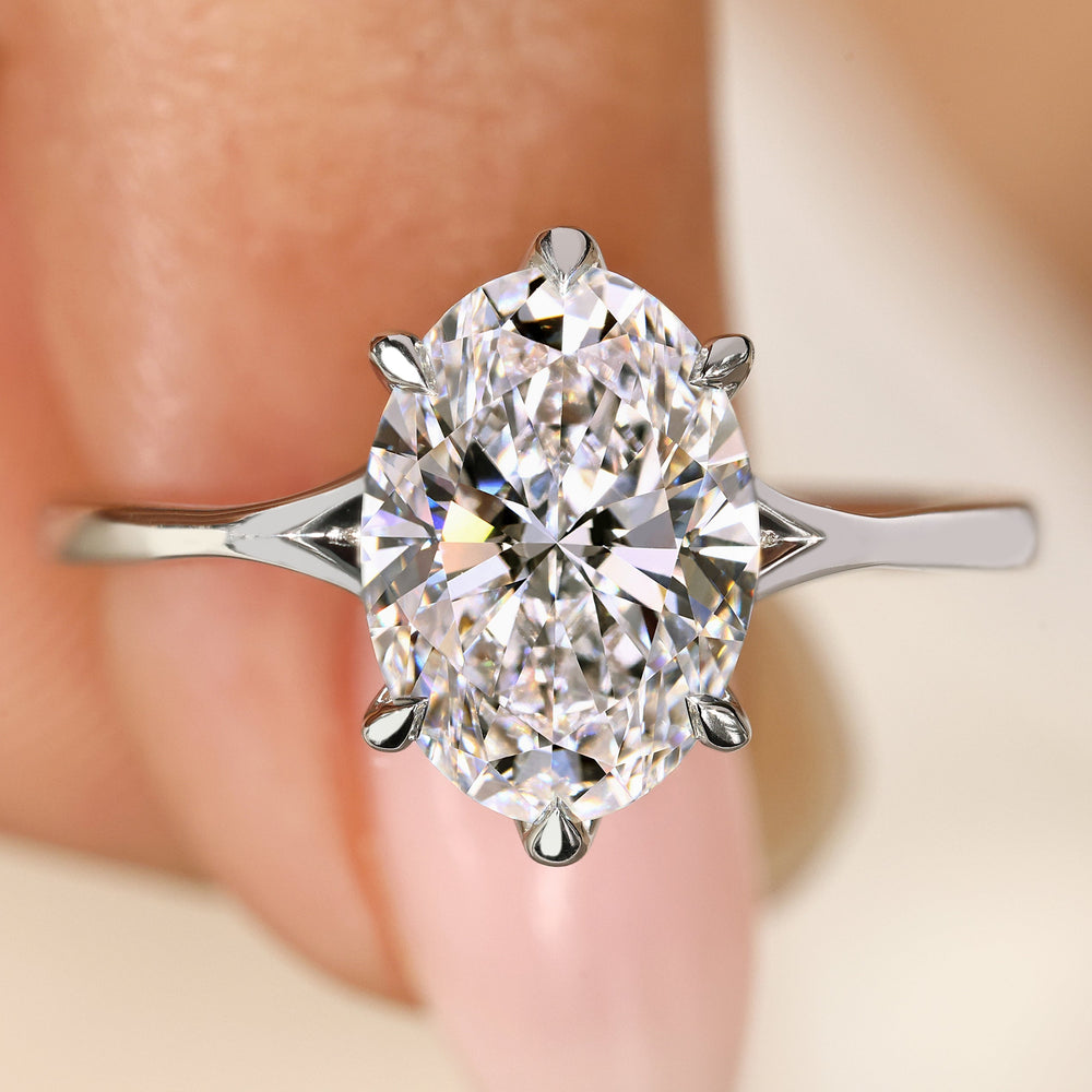Oval cut diamond ring with split shank design.
