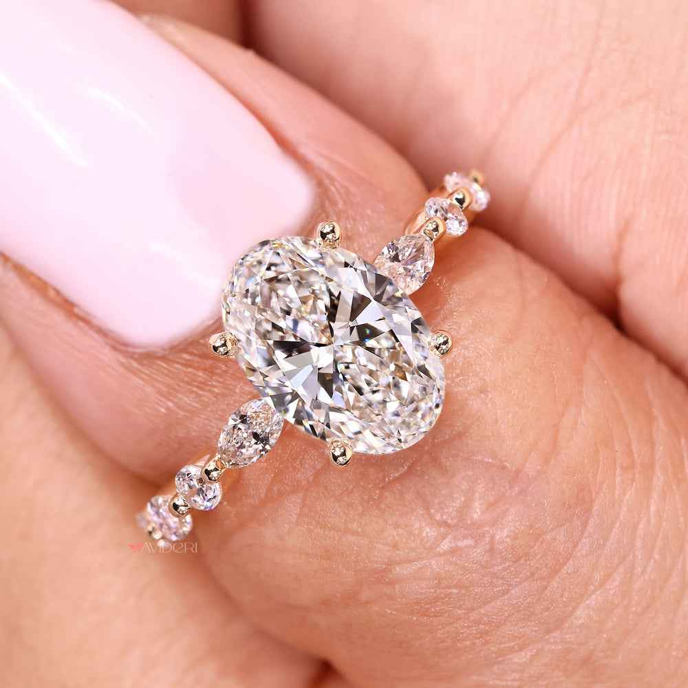 Oval diamond engagement ring with marquise diamond side accents
