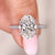 Oval engagement ring with pave band and open gallery.
