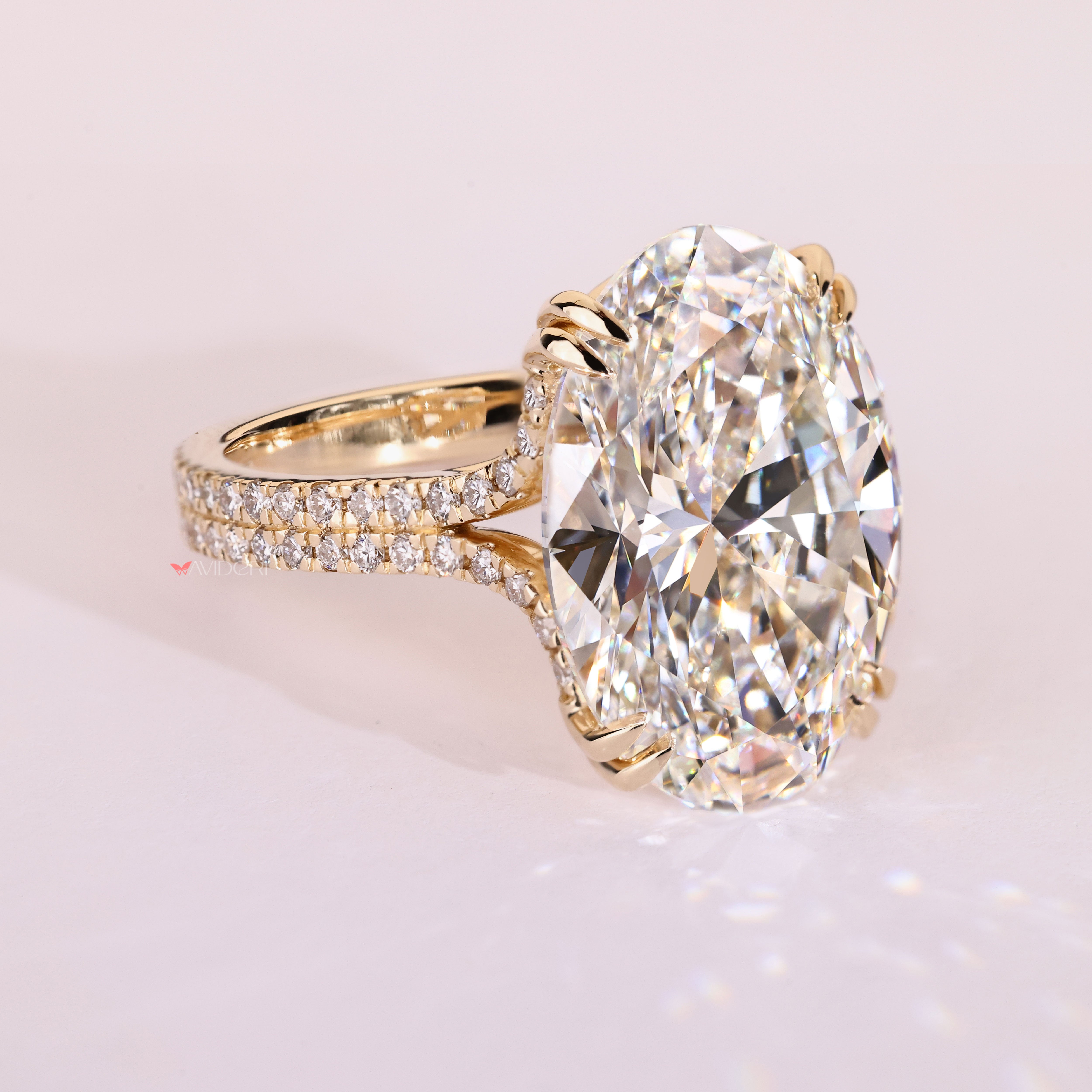 Oval diamond ring with double row pave band.
