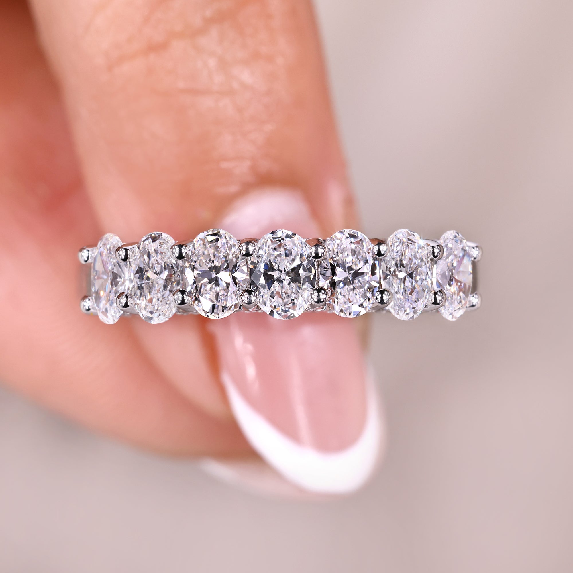 Oval diamond wedding band with seven stone band.