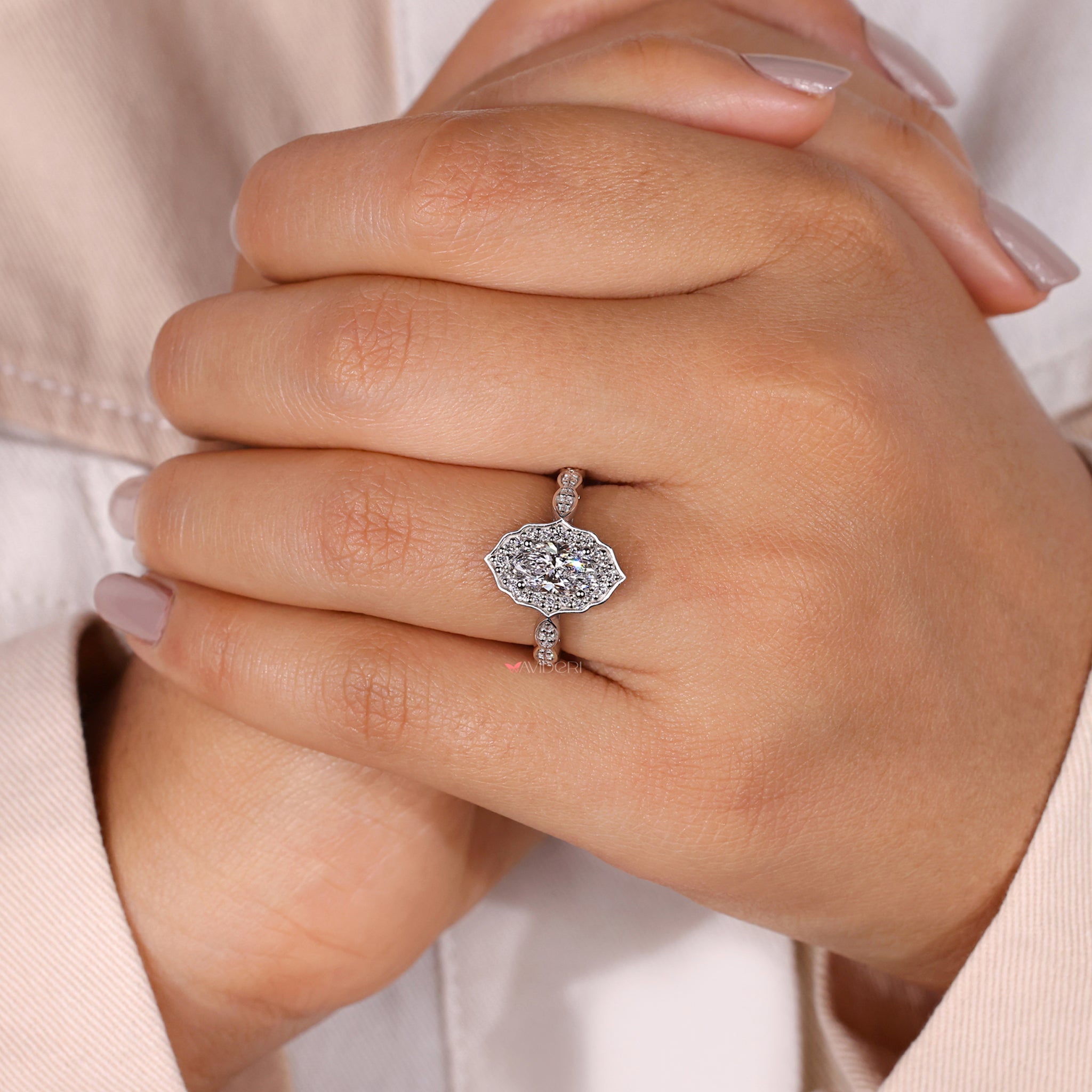Gold engagement ring with a marquise shape outline shank ring.
