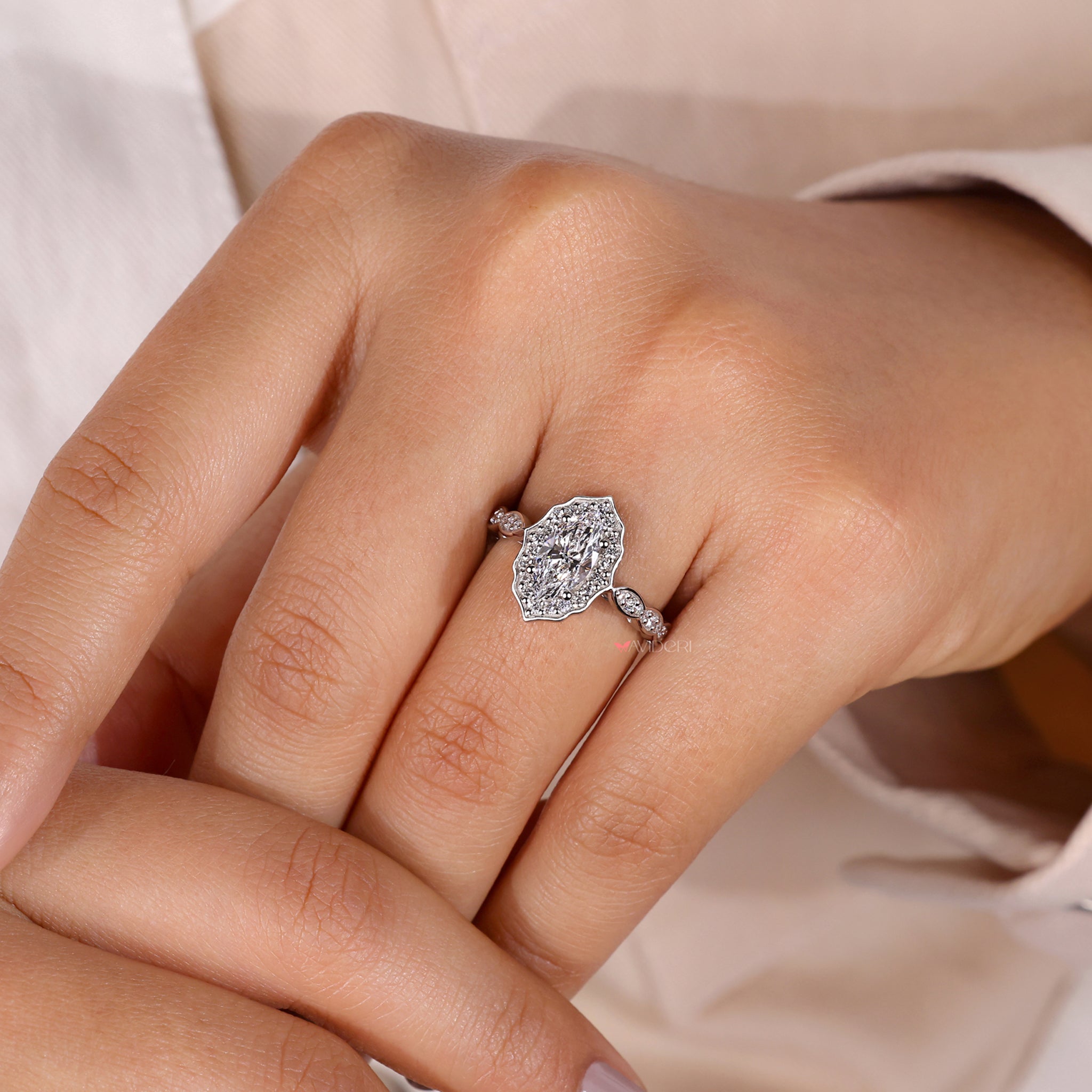 Marquise diamond ring with a halo setting.

