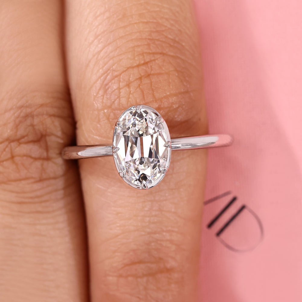 Oval old European cut solitaire ring with vintage design.