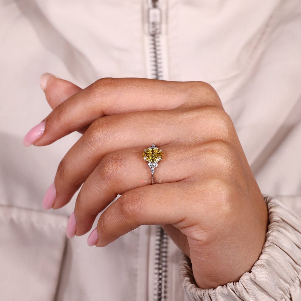 IGI certified oval yellow diamond ring with side stones.
