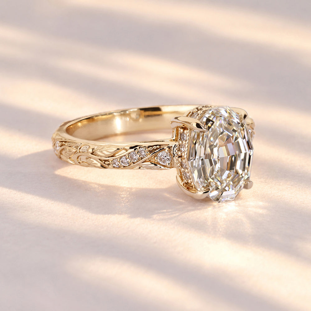 Oval step cut diamond ring with four claw prongs
