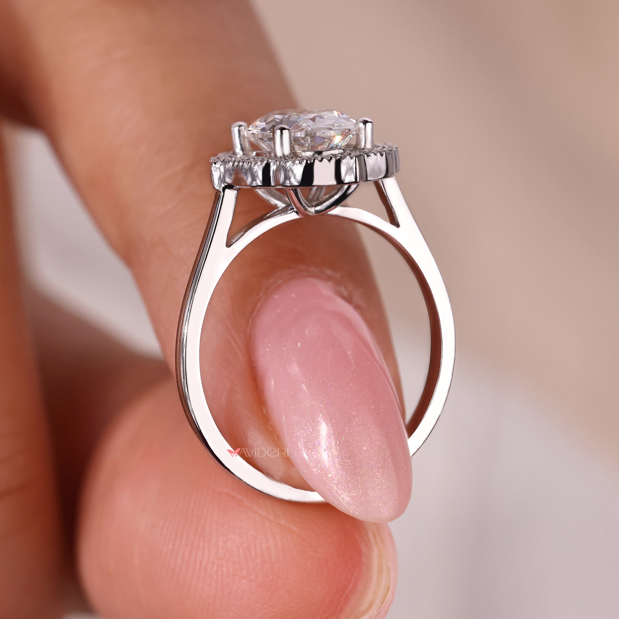 White gold ring with a sparkling round cut halo diamond centerpiece.