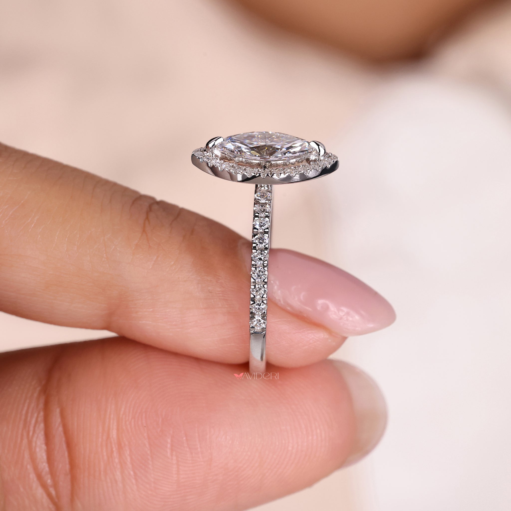 Compass prong setting marquise cut engagement ring with pave stones for a secure and elegant finish.

