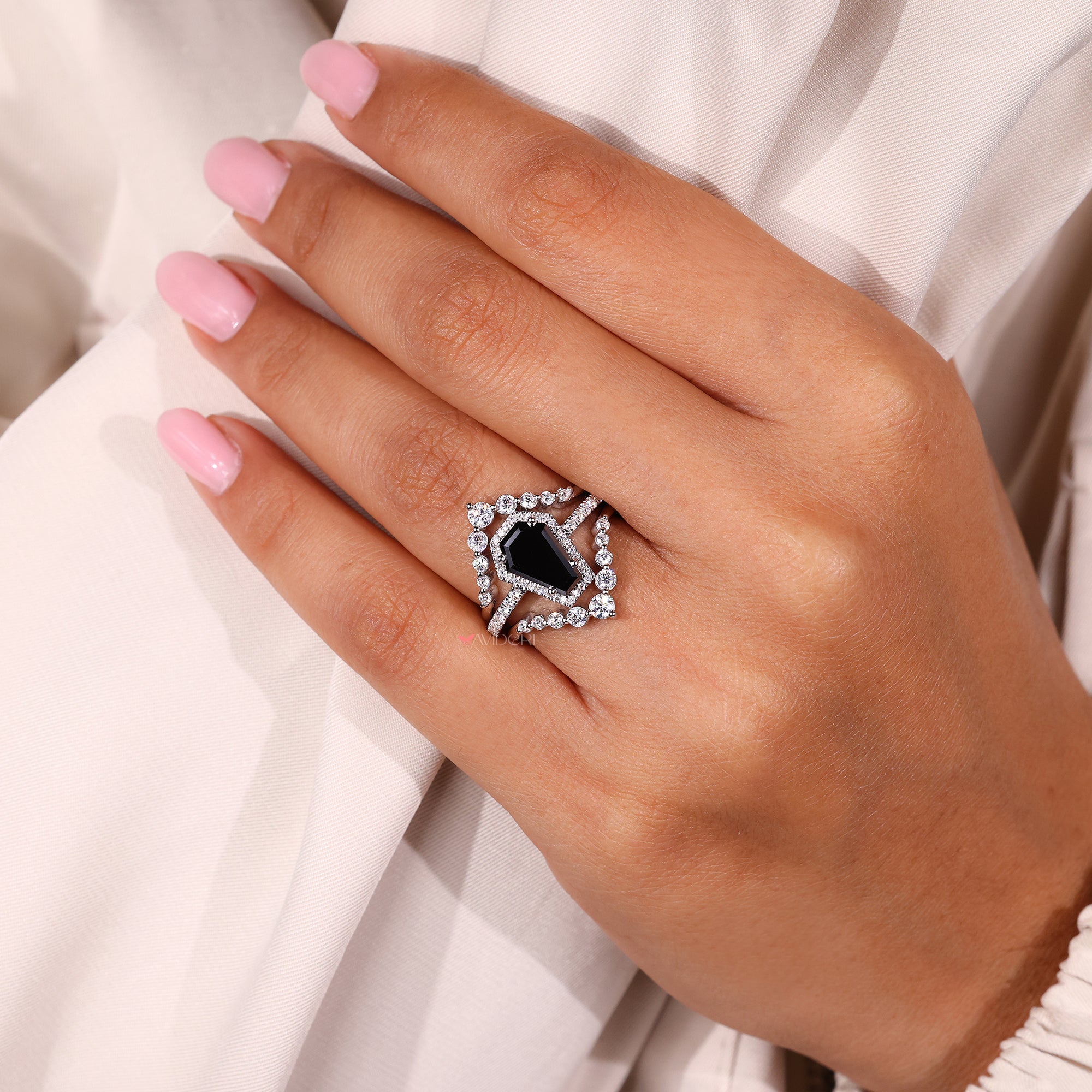 Black moissanite ring set in a coffin engagement ring for bold beauty.