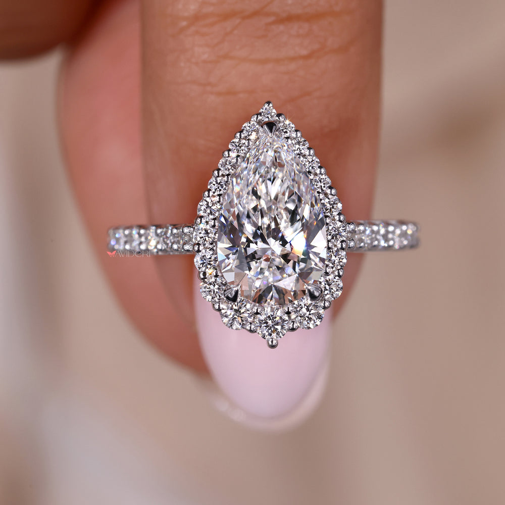 Halo engagement ring with pear shaped diamond for a unique and elegant style.
