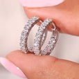 Diamond hoop earrings in white gold with pave diamonds.