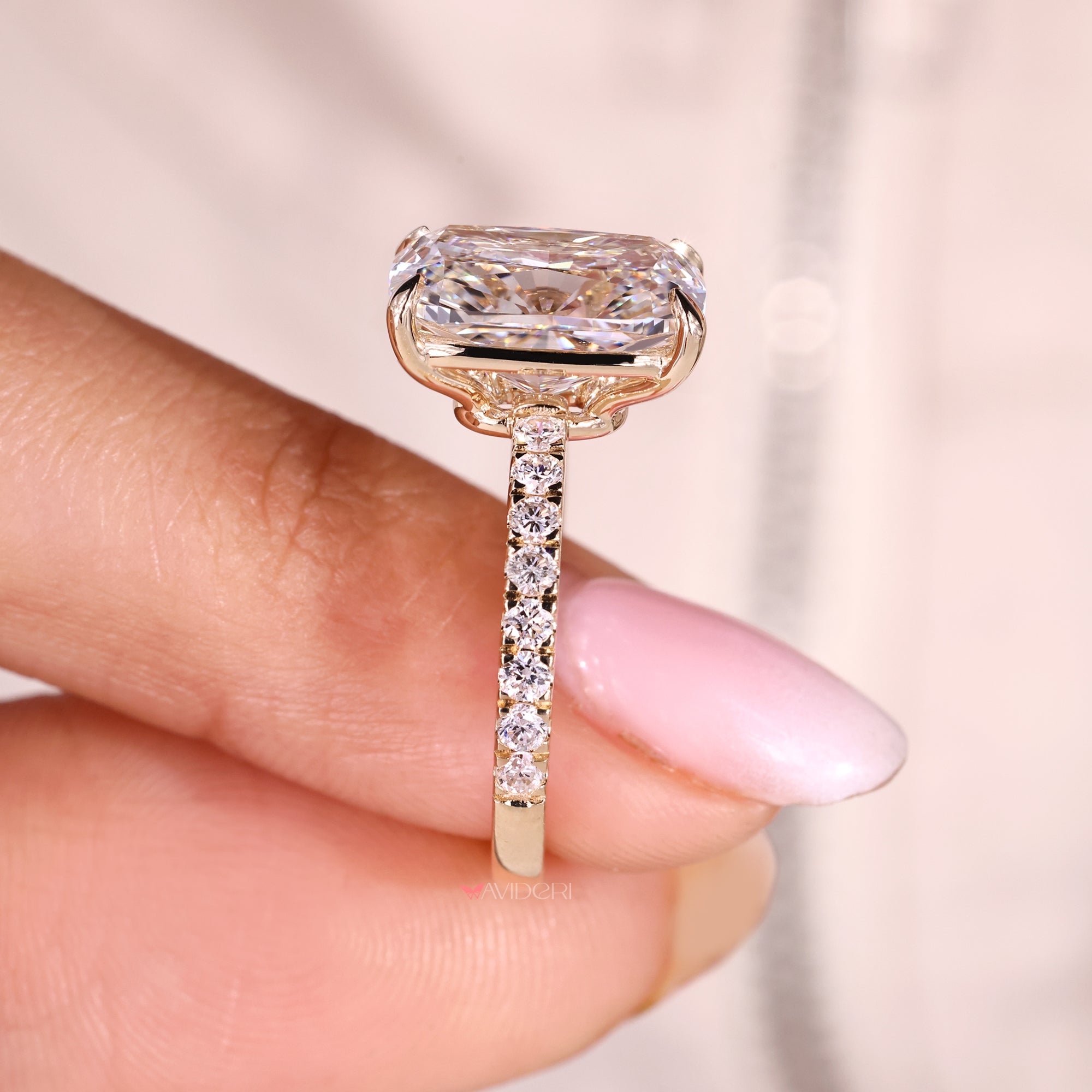 Four claw prong cushion cut diamond ring in pave style.
