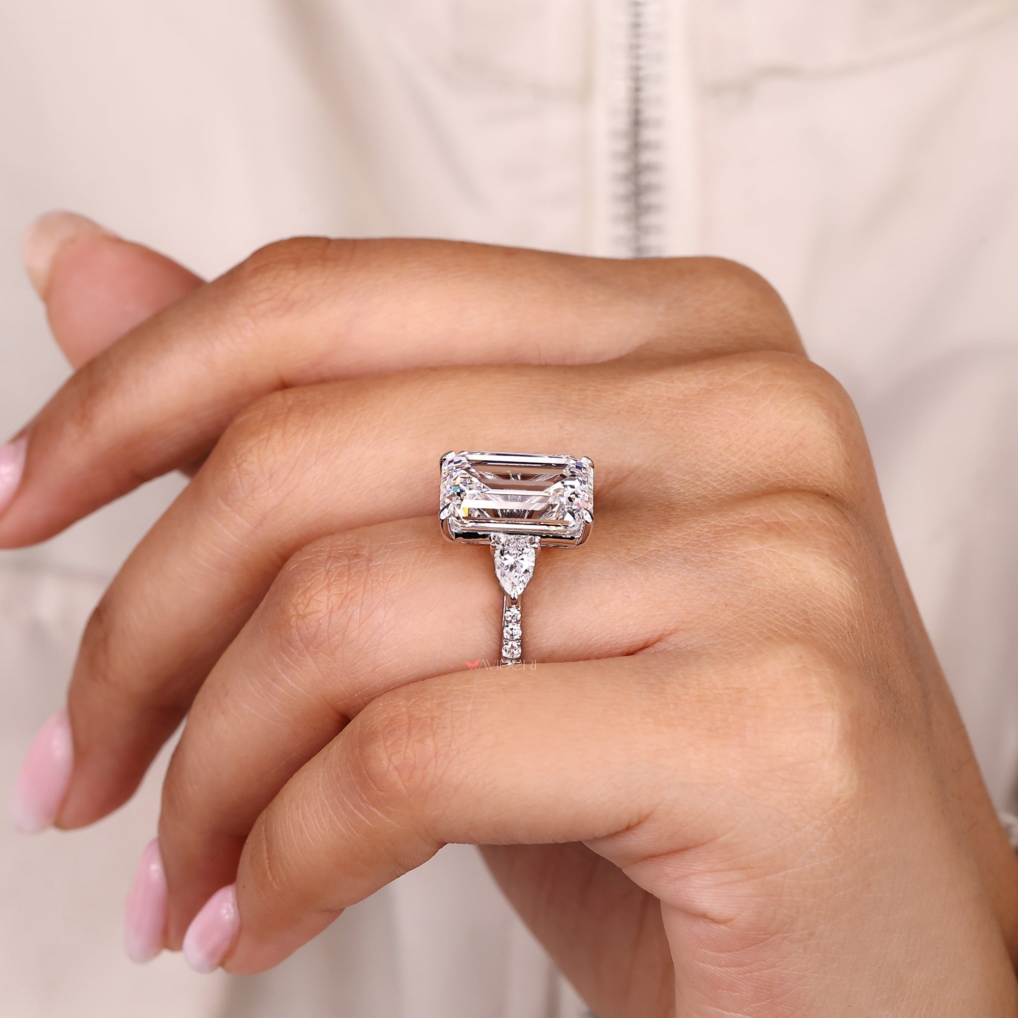 Emerald cut diamond ring with four claw prong setting.
