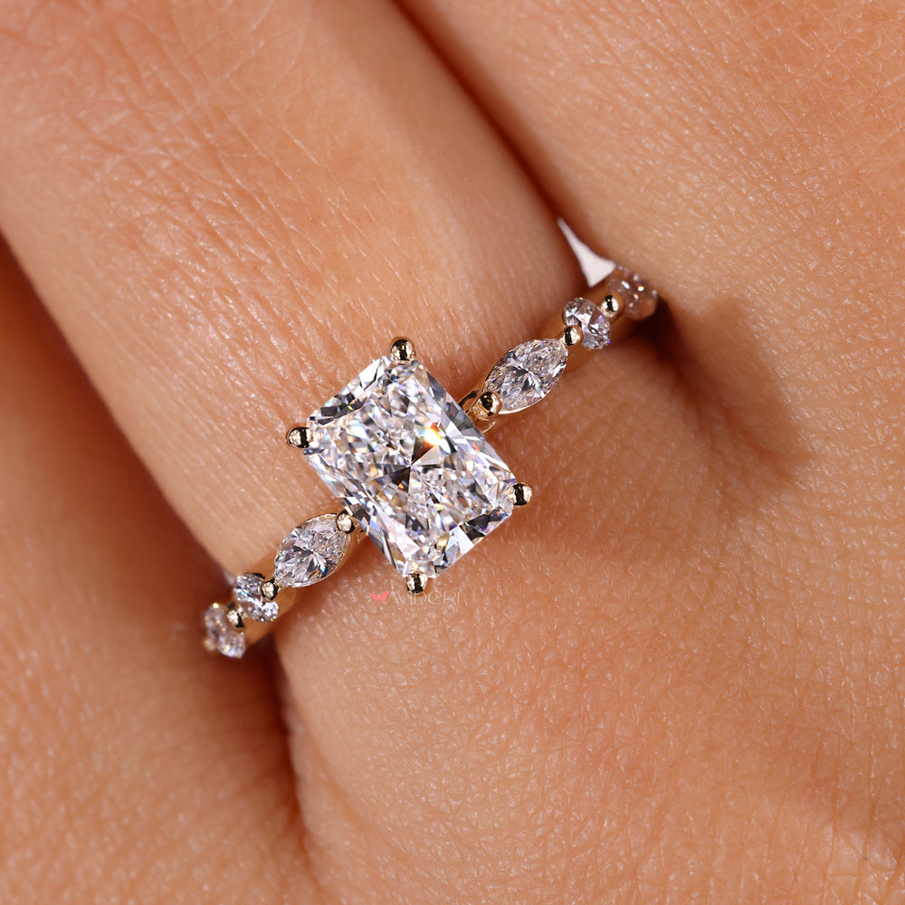 Handmade ring with radiant engagement ring and marquise accents.
