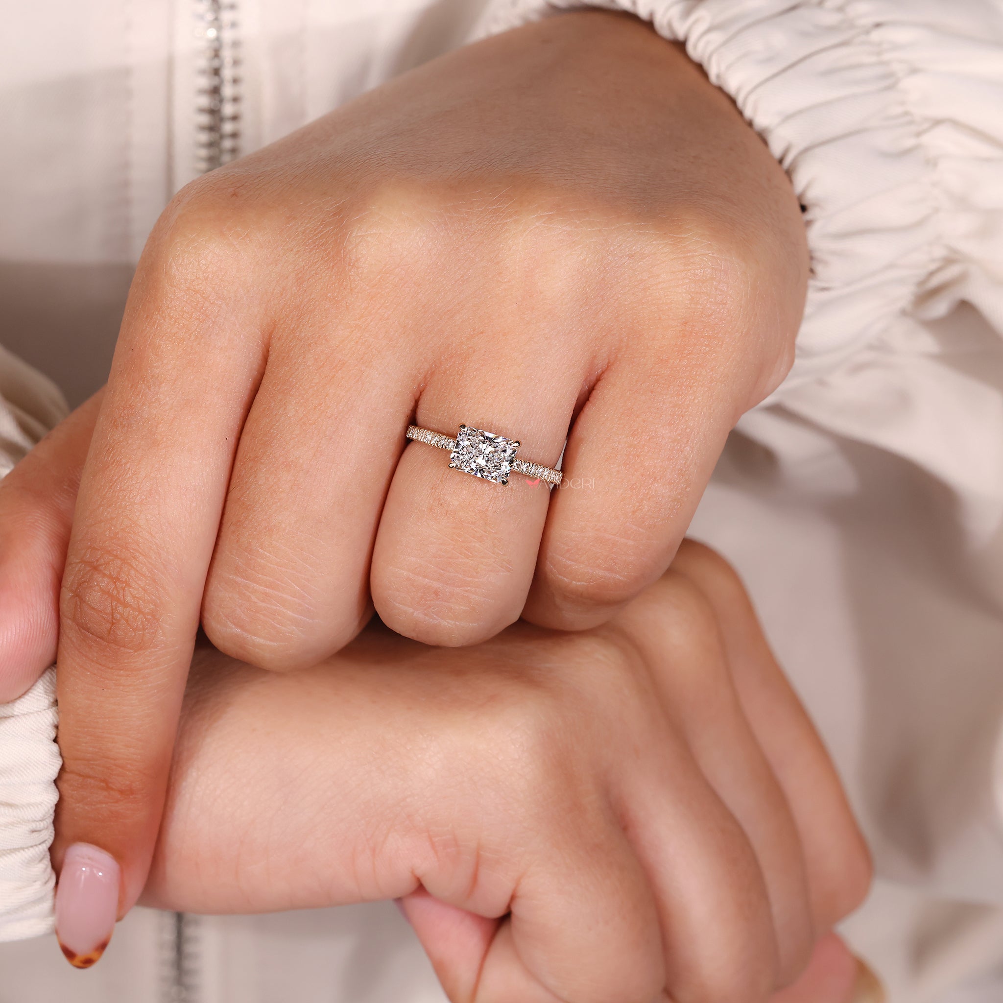 Radiant cut diamond ring with 4-prong claw setting.