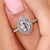Cushion Old European Cut diamond ring with halo setting in white gold.