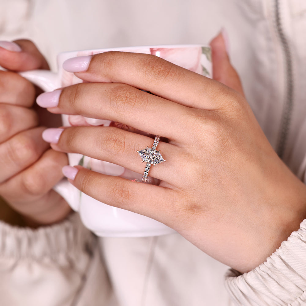 Marquise ring with round diamond hidden halo.
