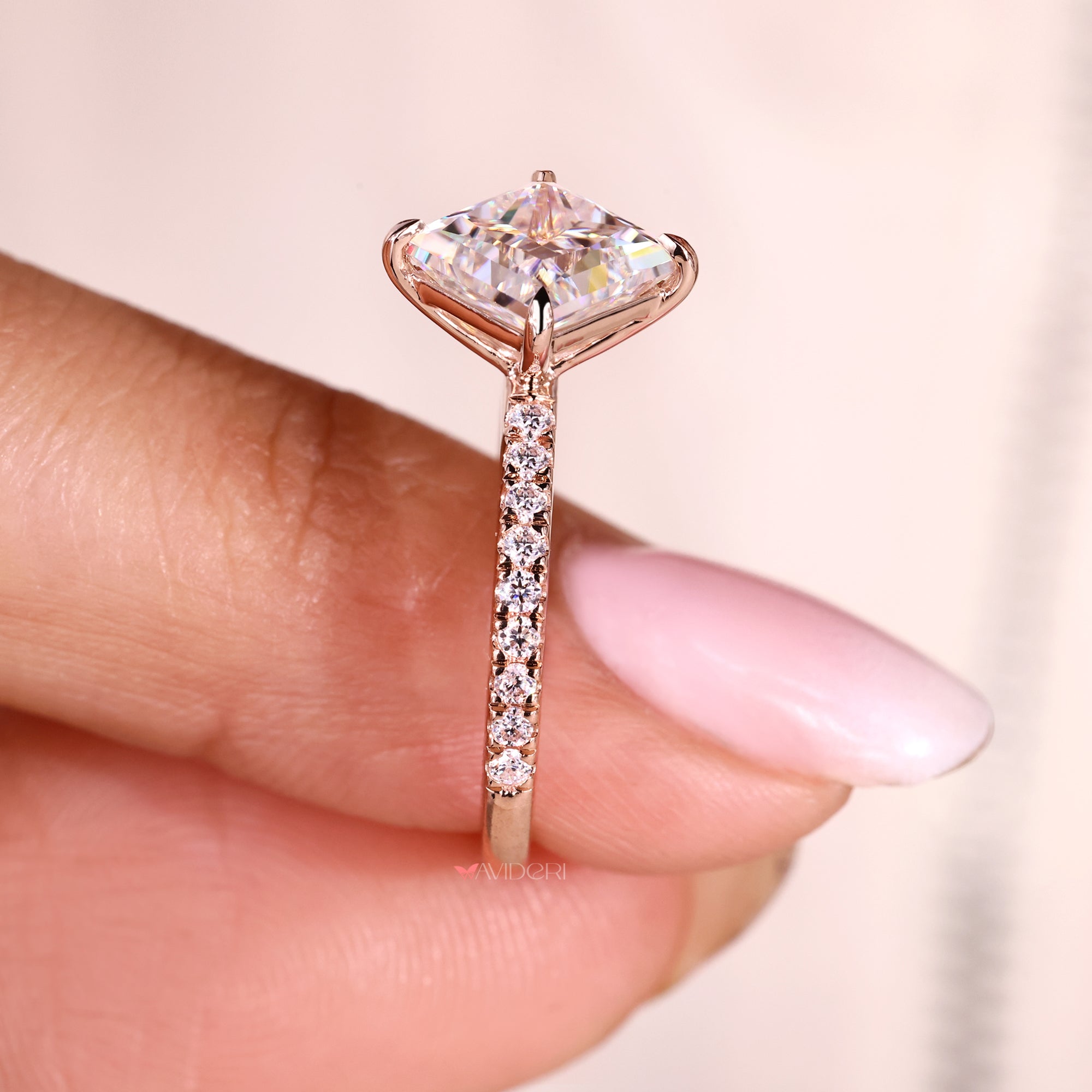 Rose gold pave engagement ring with a princess cut centrepiece.