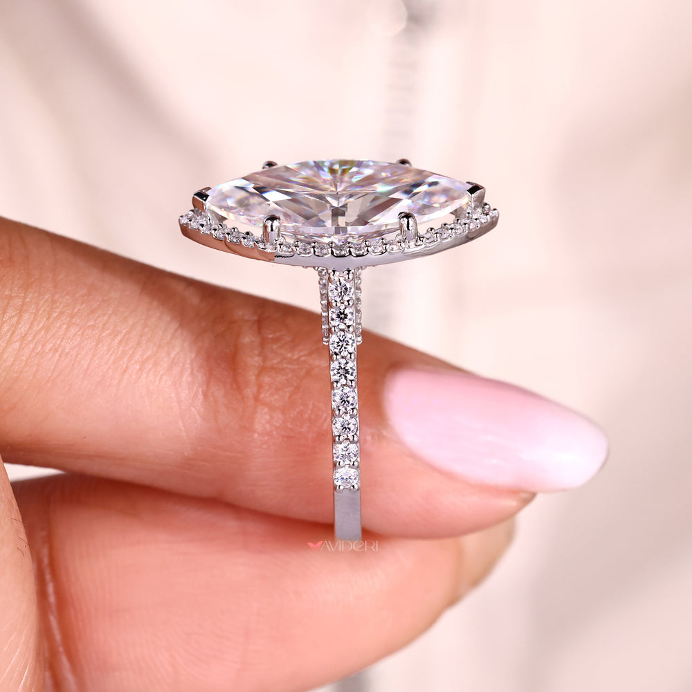 Halo pave marquise ring with round cut moissanite center.
